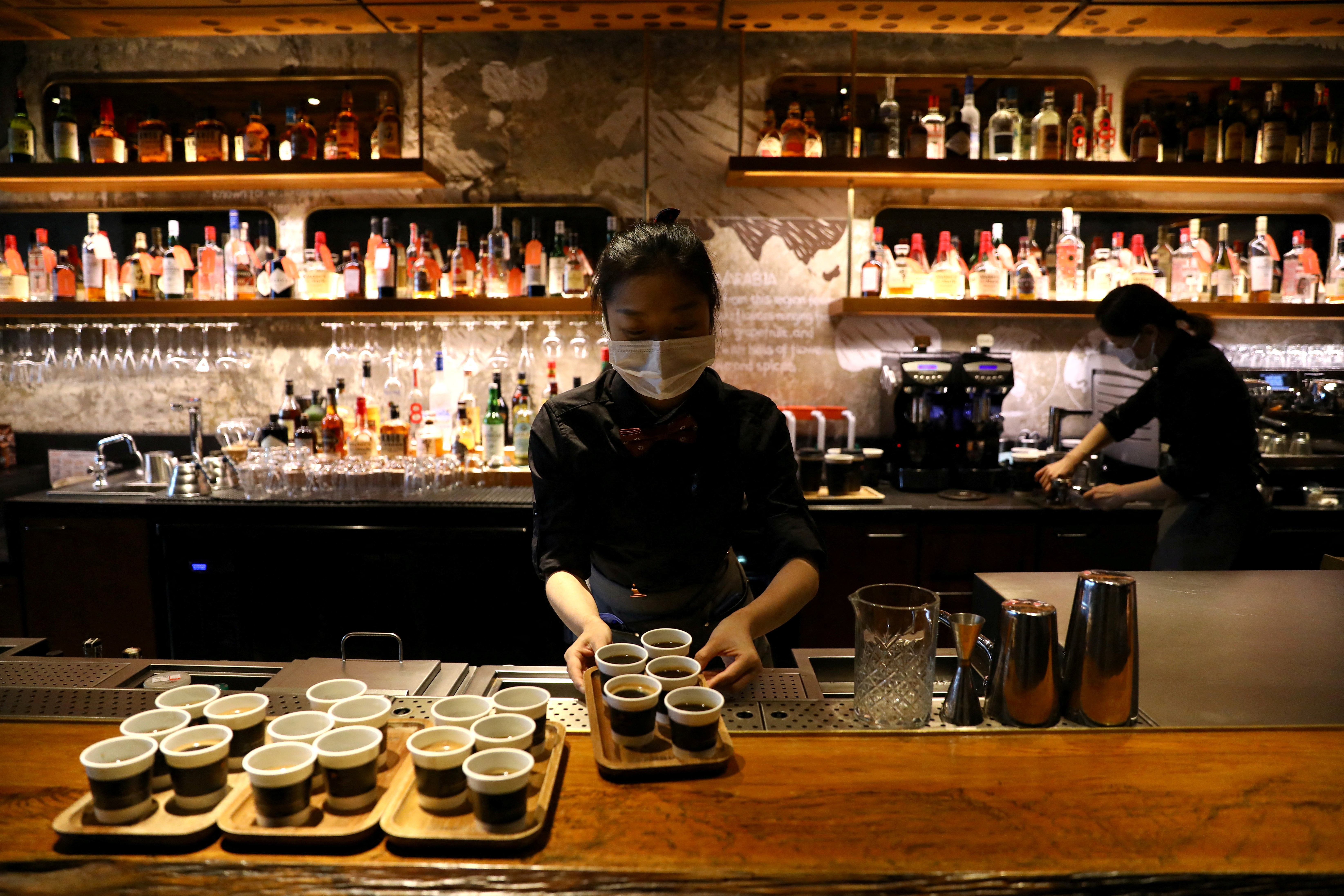 A barista serves coffee at a Starbucks flagship store in Beijing