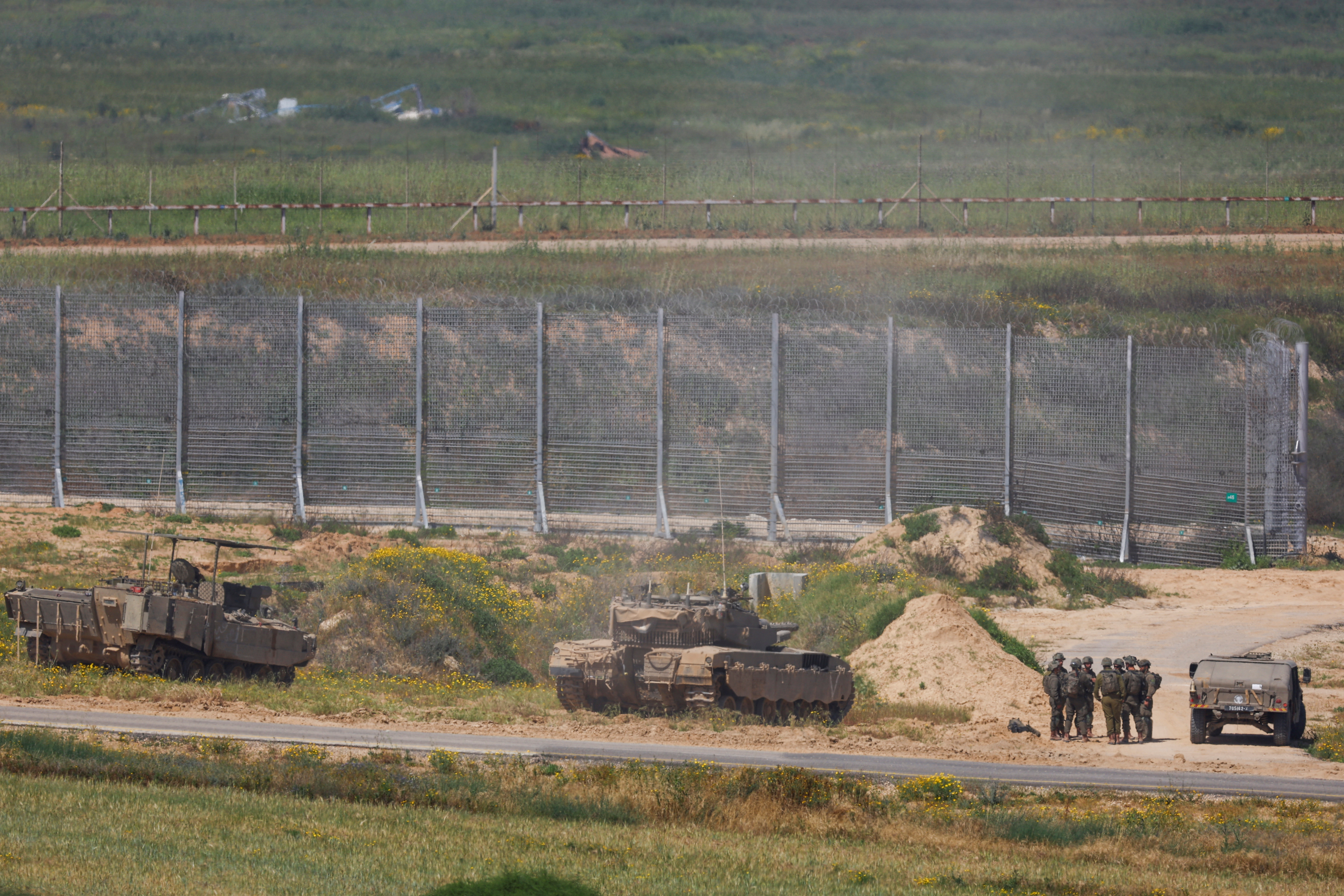Israeli military vehicles hold position near the Israel-Gaza border