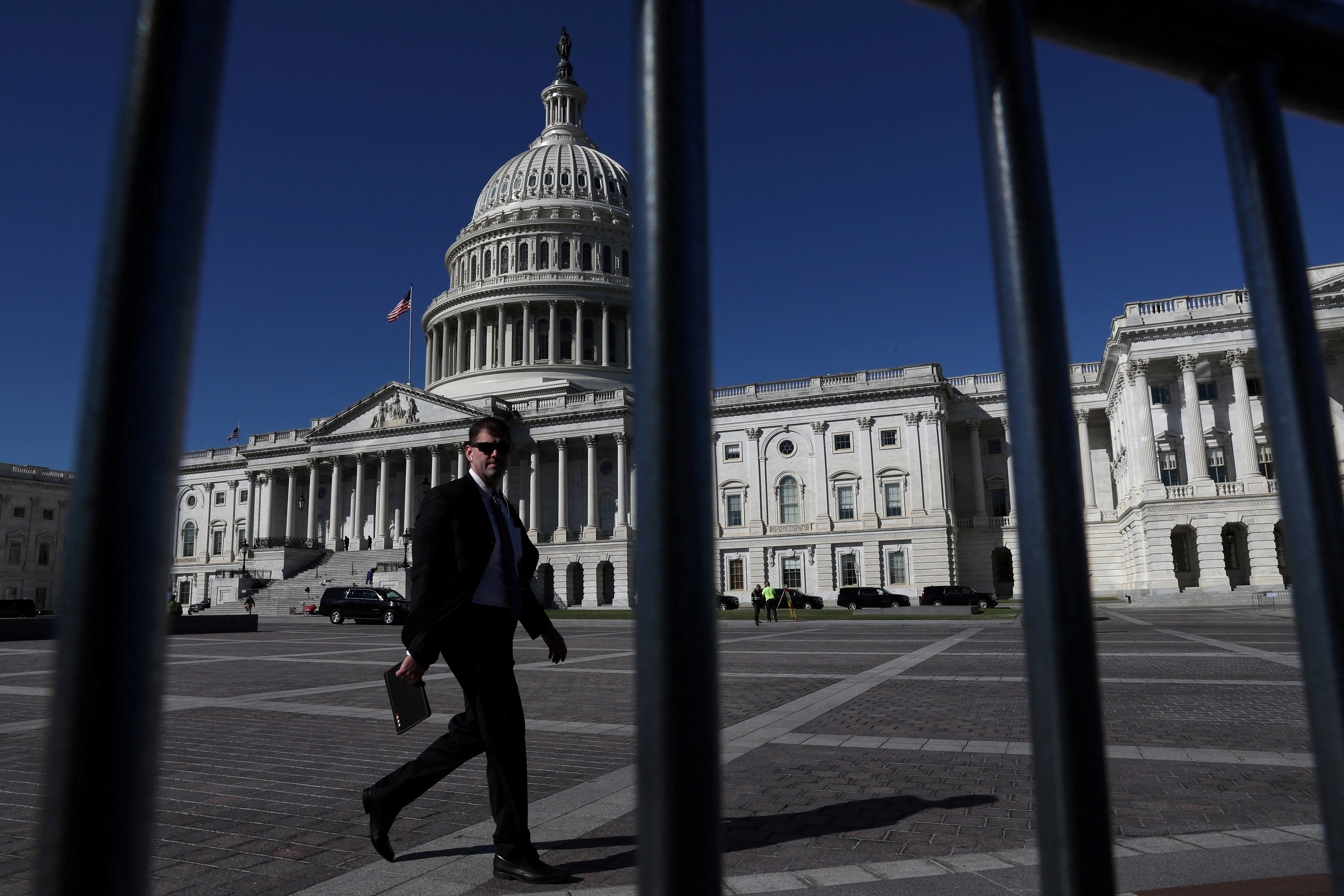 A man walks past the U.S. Capitol building as a government shutdown looms in Washington