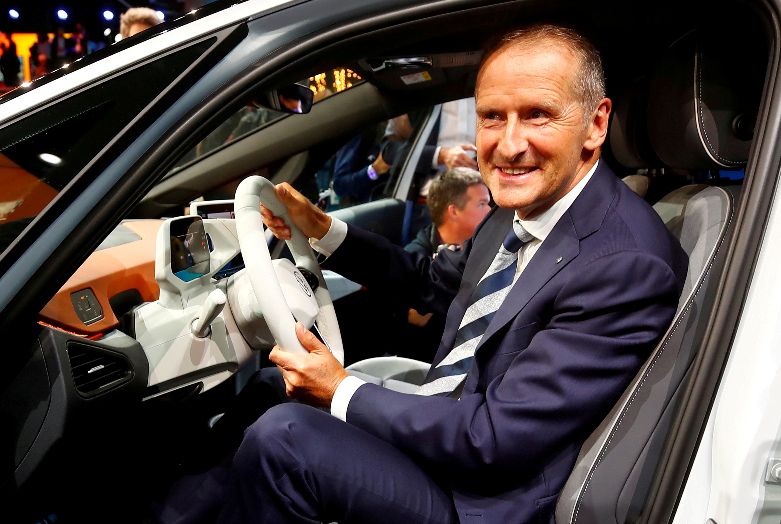 Herbert Diess, CEO of German carmaker Volkswagen AG, poses in an ID.3 pre-production prototype during the presentation of Volkswagen's new electric car on the eve of the International Frankfurt Motor Show IAA in Frankfurt, Germany September 9, 2019. REUTERS/Wolfgang Rattay/File Photo