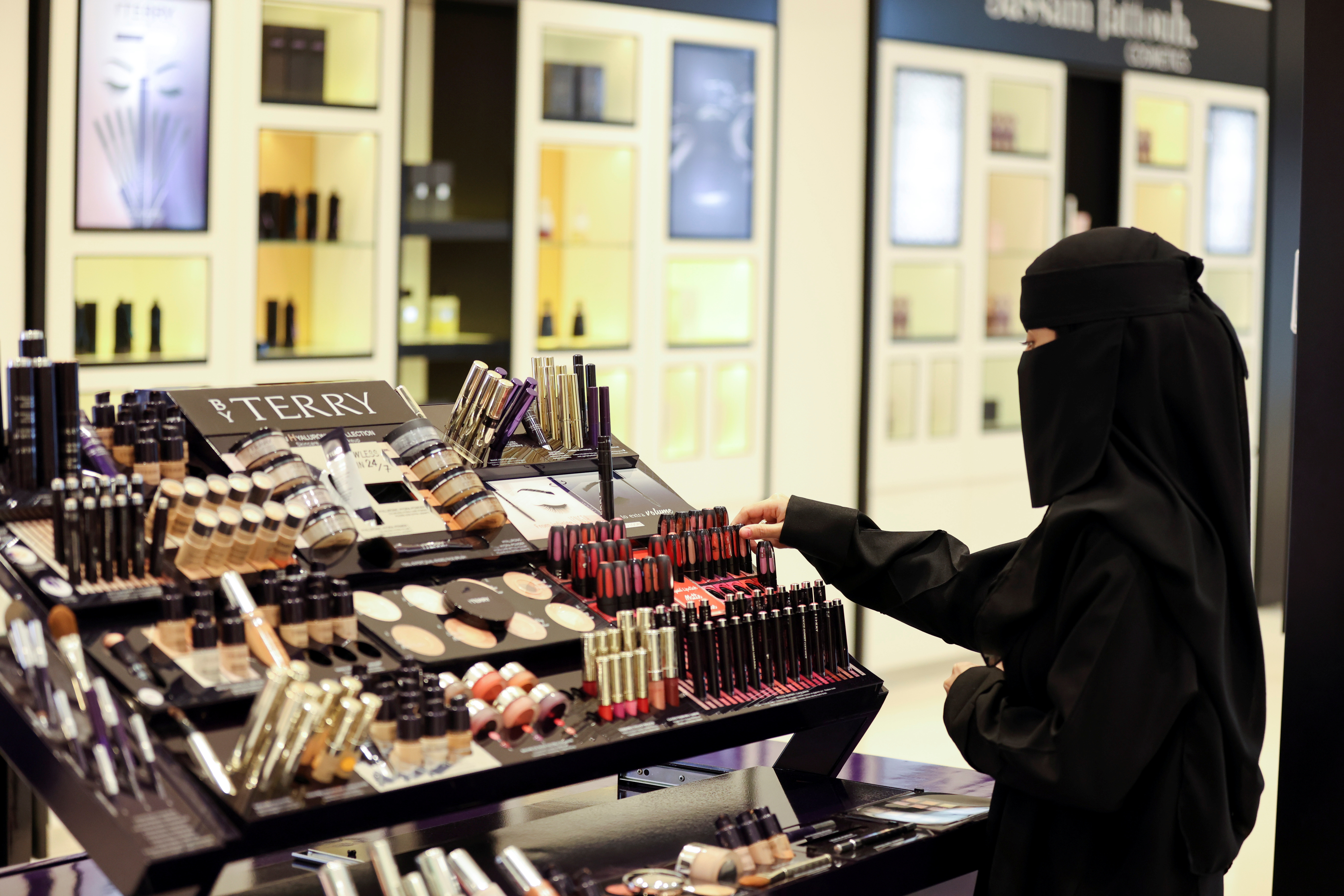 Saudi woman buys makeup from a cosmetic shop in Centria Mall in Riyadh