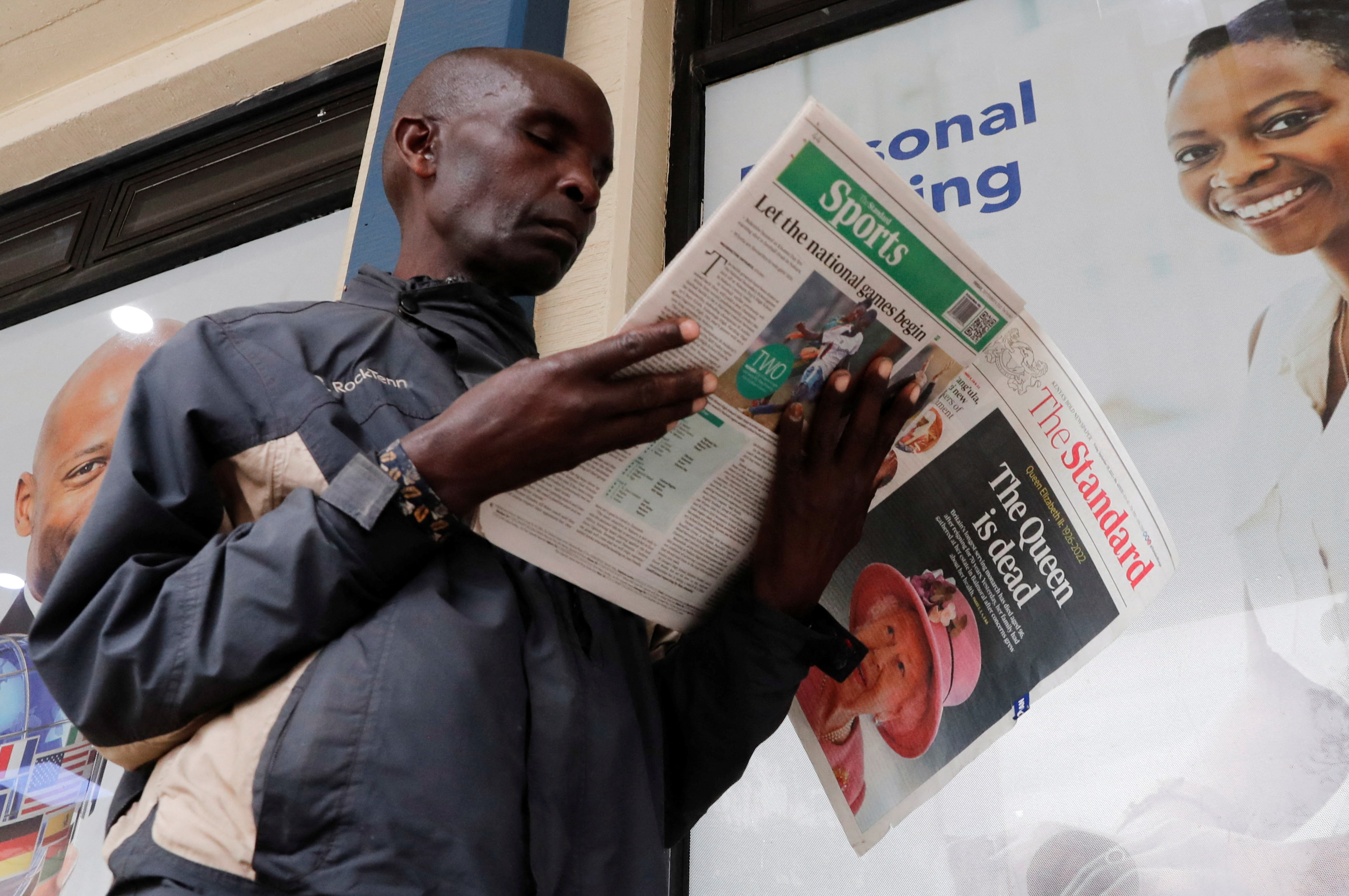 A man reads a newspaper reporting on the death of Queen Elizabeth, Britain's longest-reigning monarch, in Nairobi