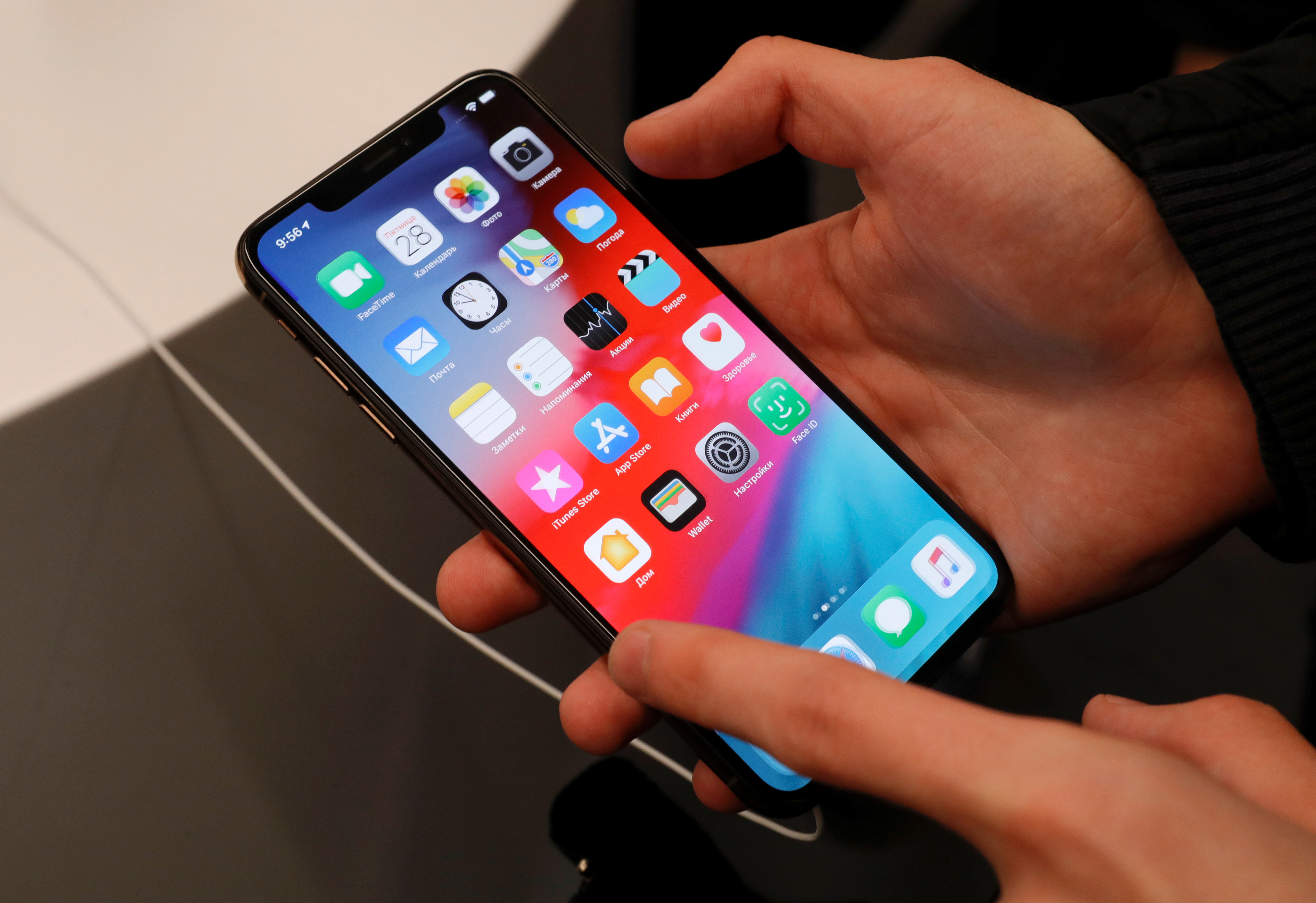A customer tests a smartphone during the launch of the new iPhone XS and XS Max sales at a shop in Moscow