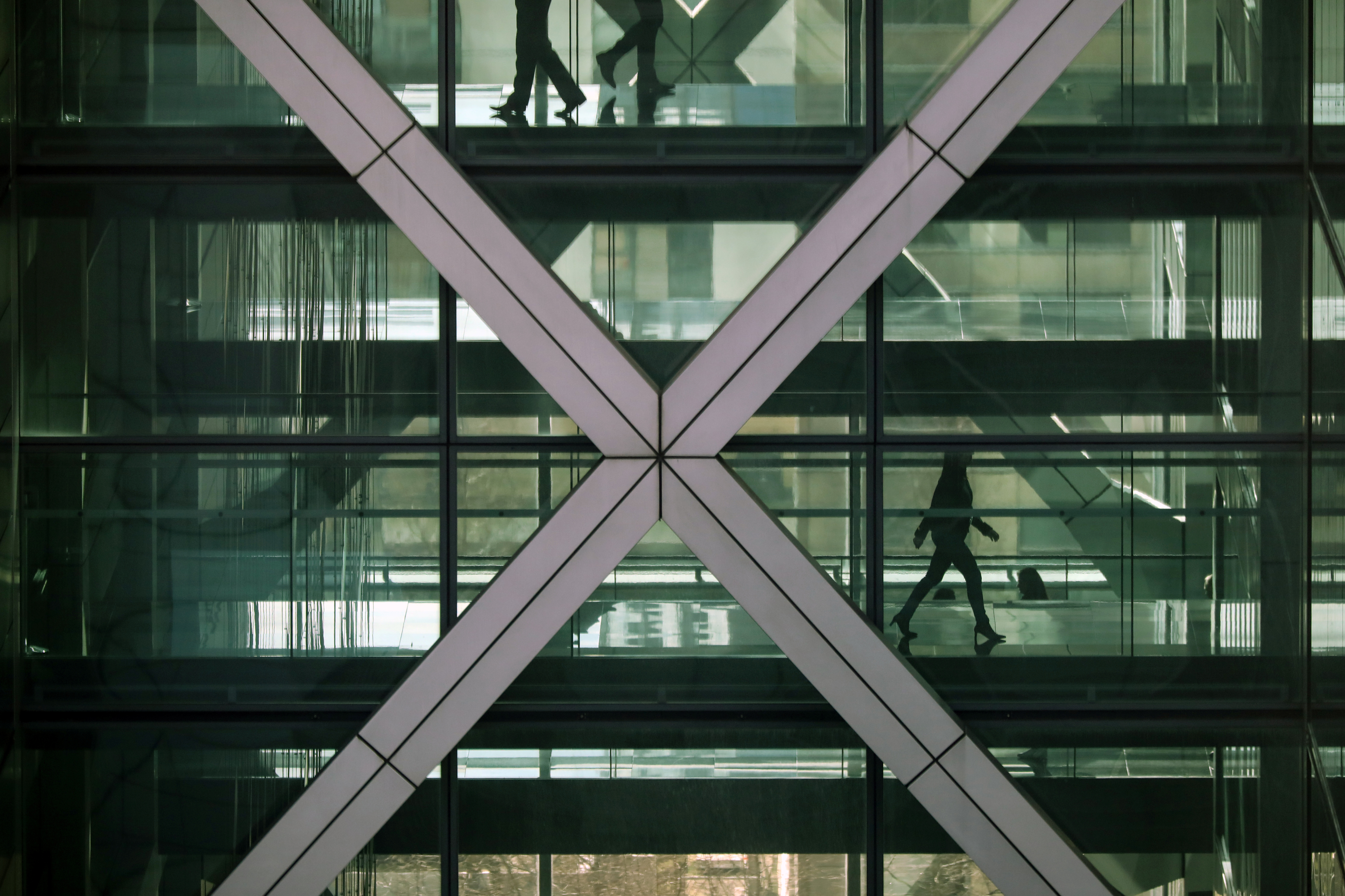 People walk in an office in the financial centre of Canary Wharf