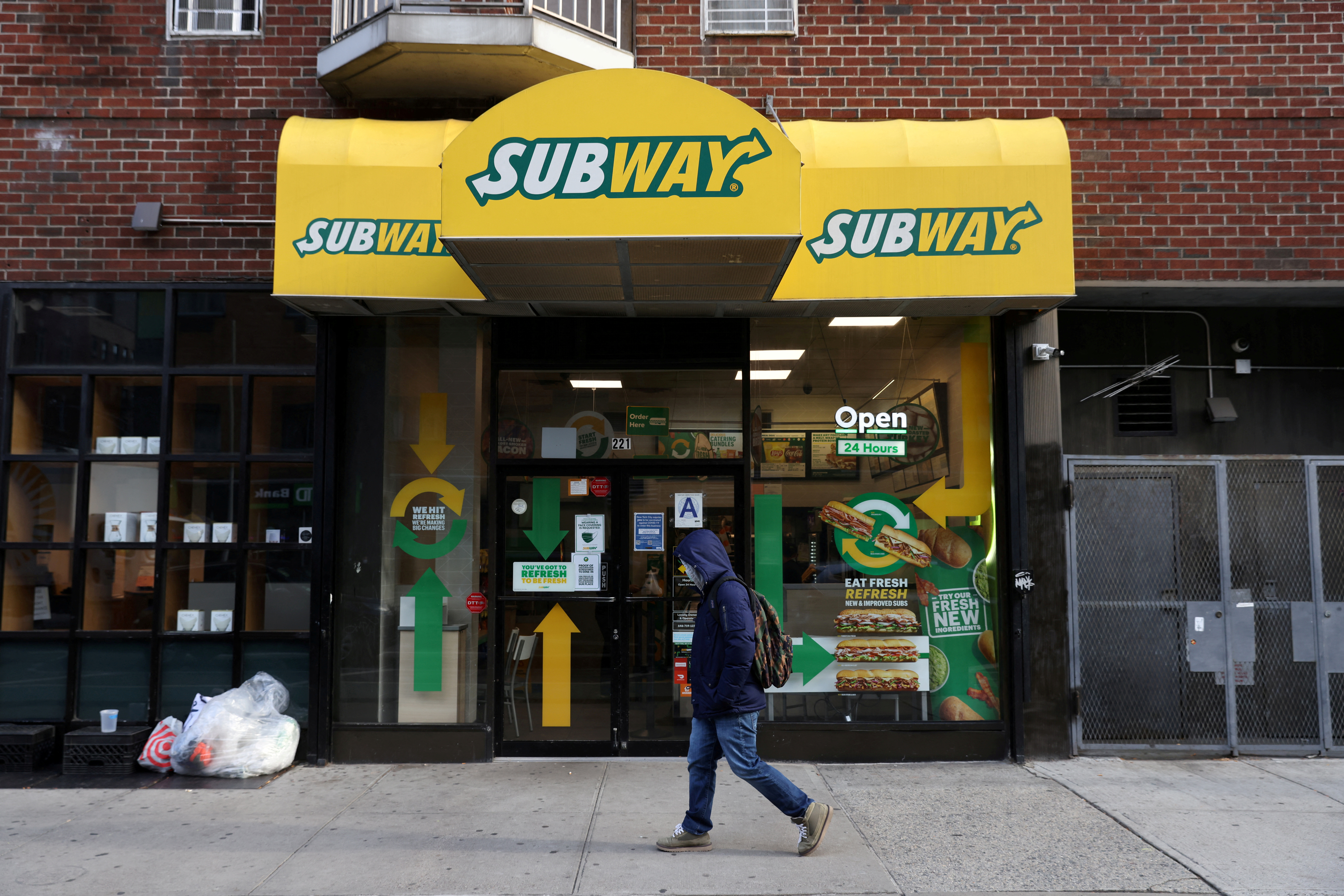 A person walks by a Subway restaurant in Manhattan, New York City
