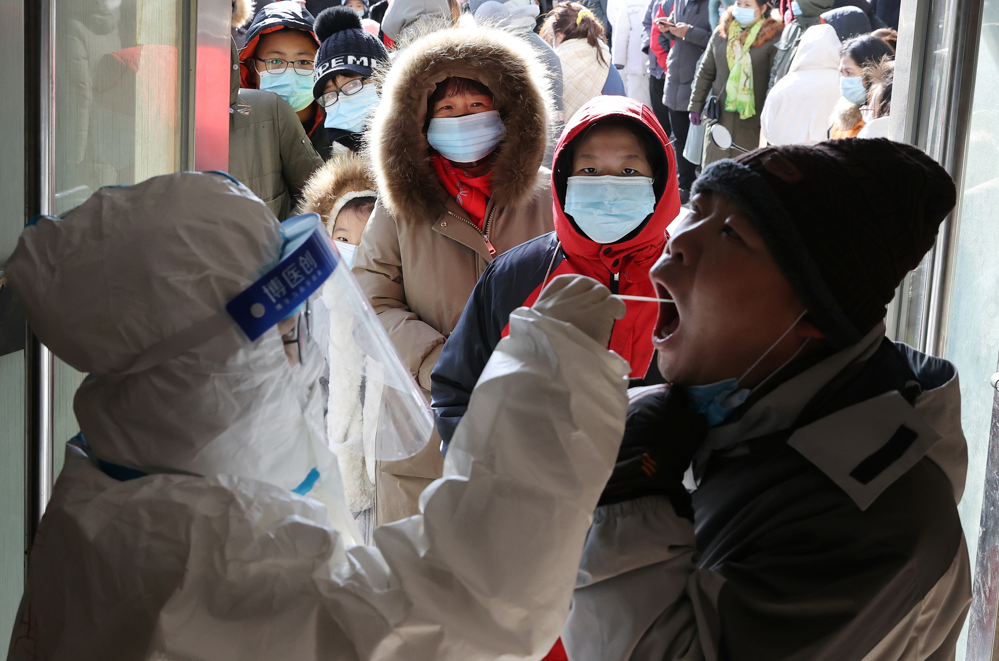 Medical worker collects a swab from a resident during a mass nucleic acid testing in Shijiazhuang