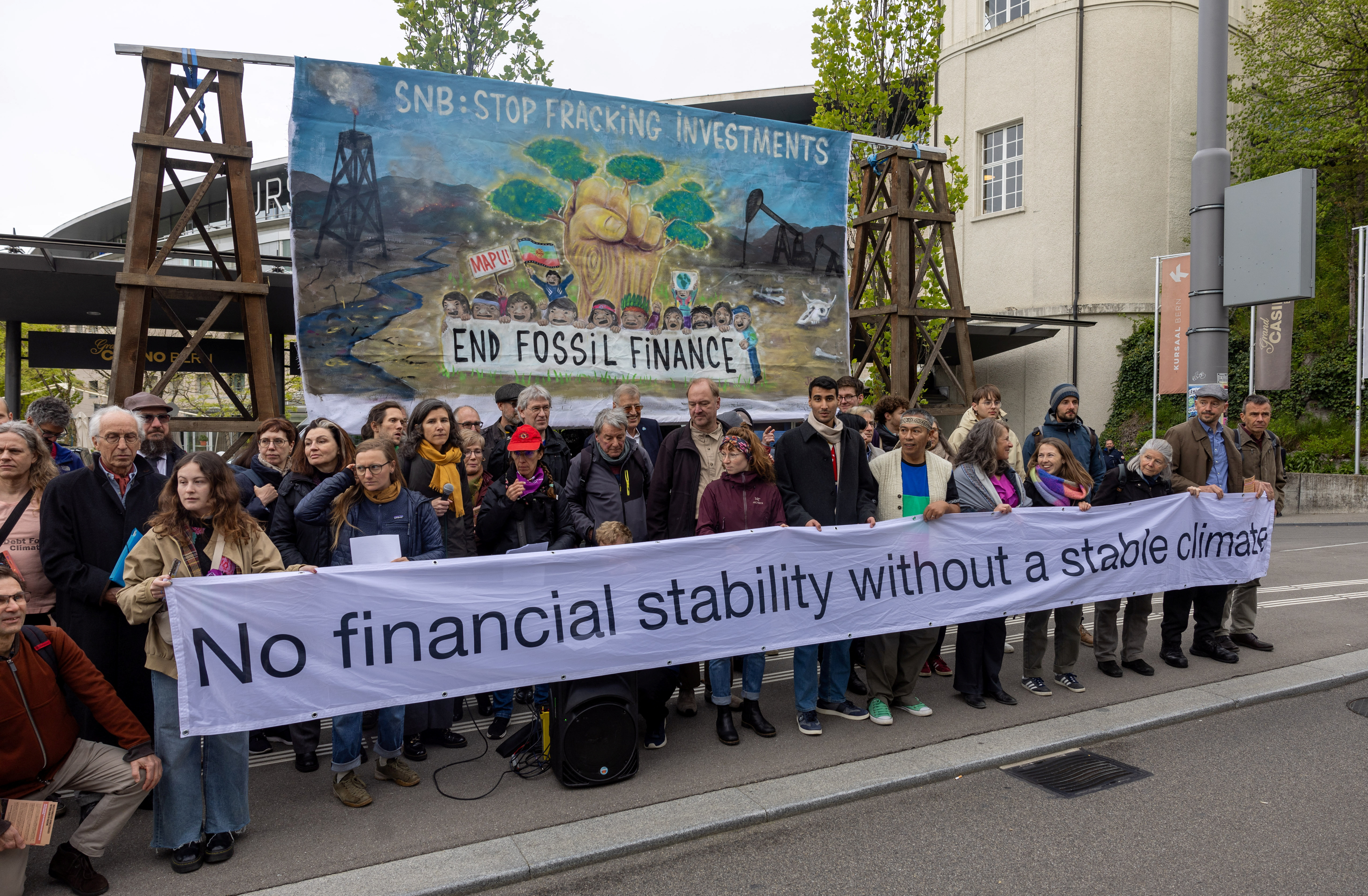Activists protest against fossil investments before the annual general meeting of the Swiss National Bank (SNB) in Bern