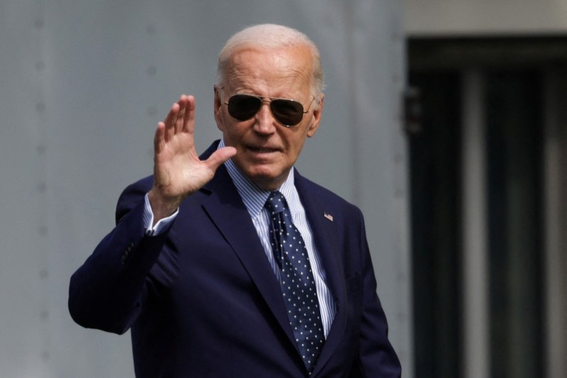 U.S. President Biden waves before boarding Marine One, as he departs the White House in Washington