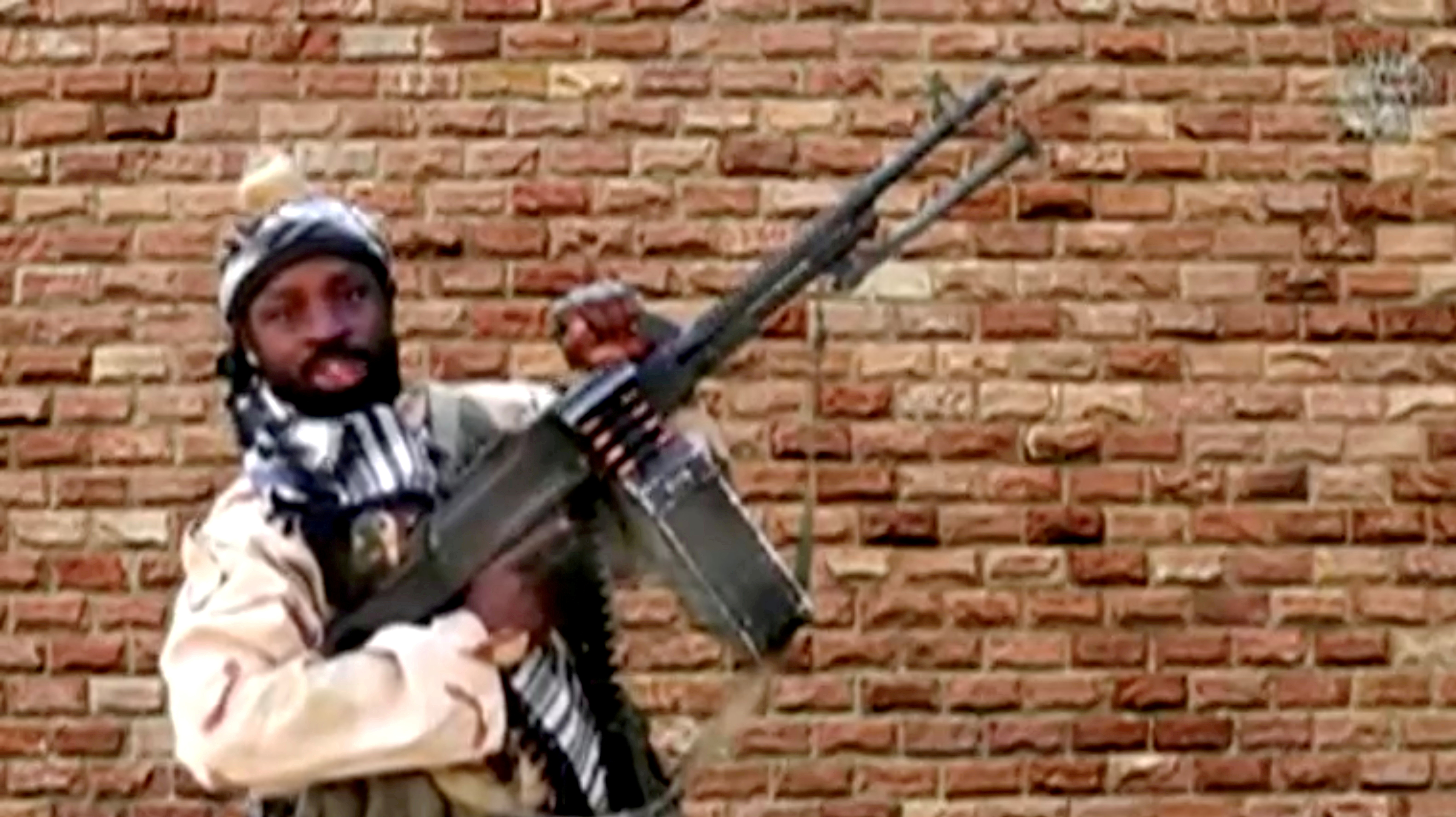 Boko Haram leader Abubakar Shekau holds a weapon in an unknown location in Nigeria