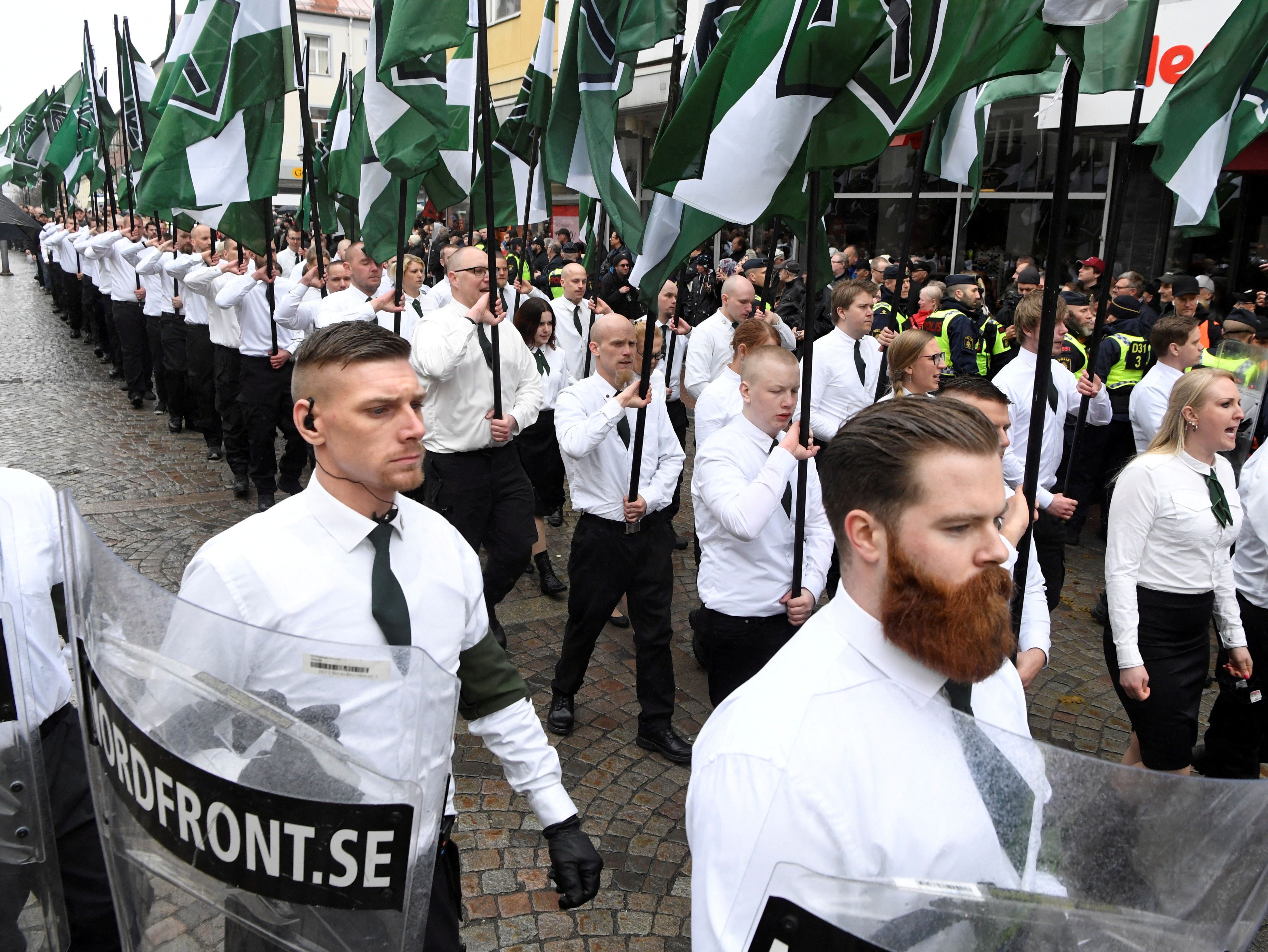 Members of the Neo-nazi Nordic Resistance Movement march through the town of Ludvika