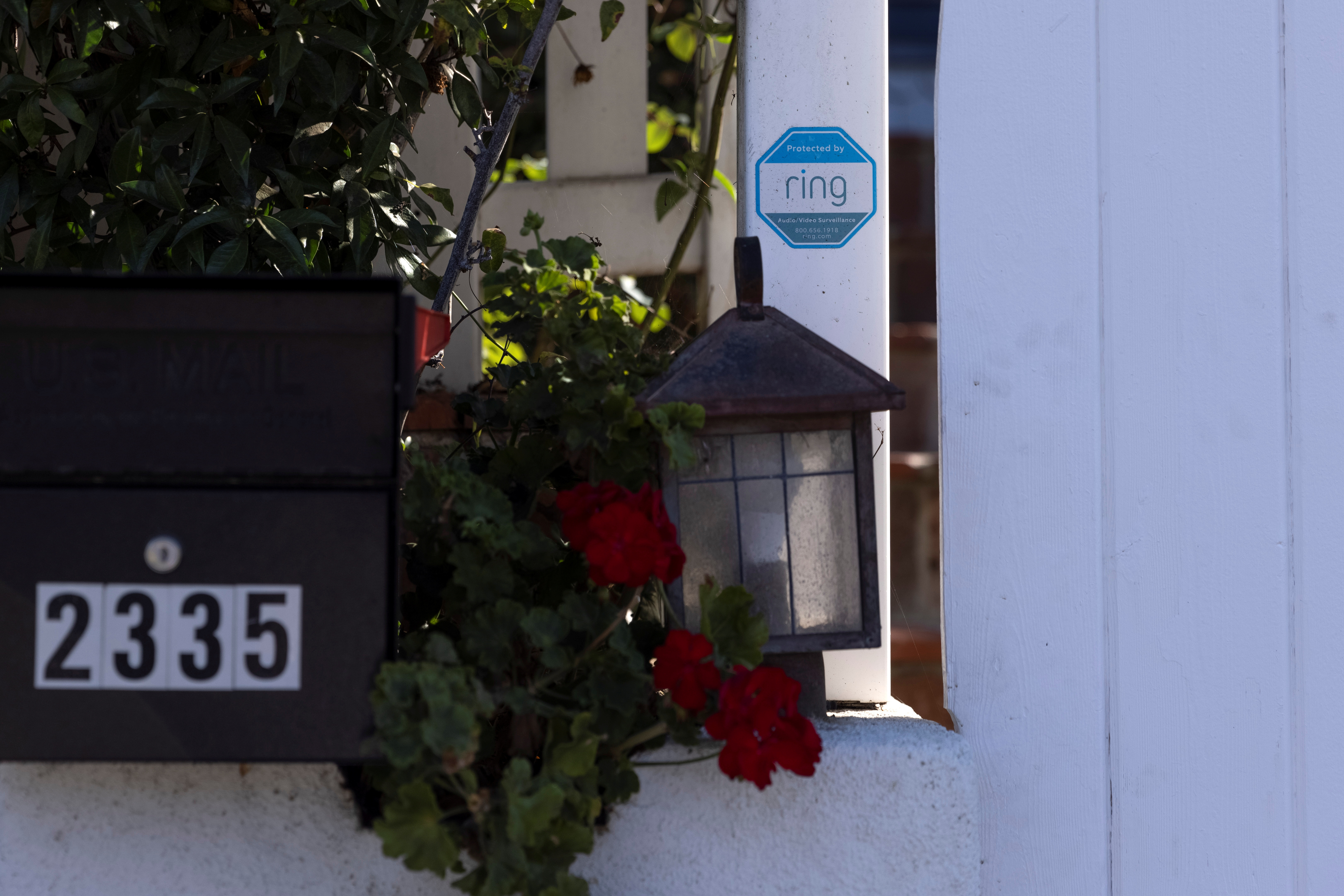 An Amazon Ring sign is shown as a security warning at the entrance to a residential home in Encinitas, California