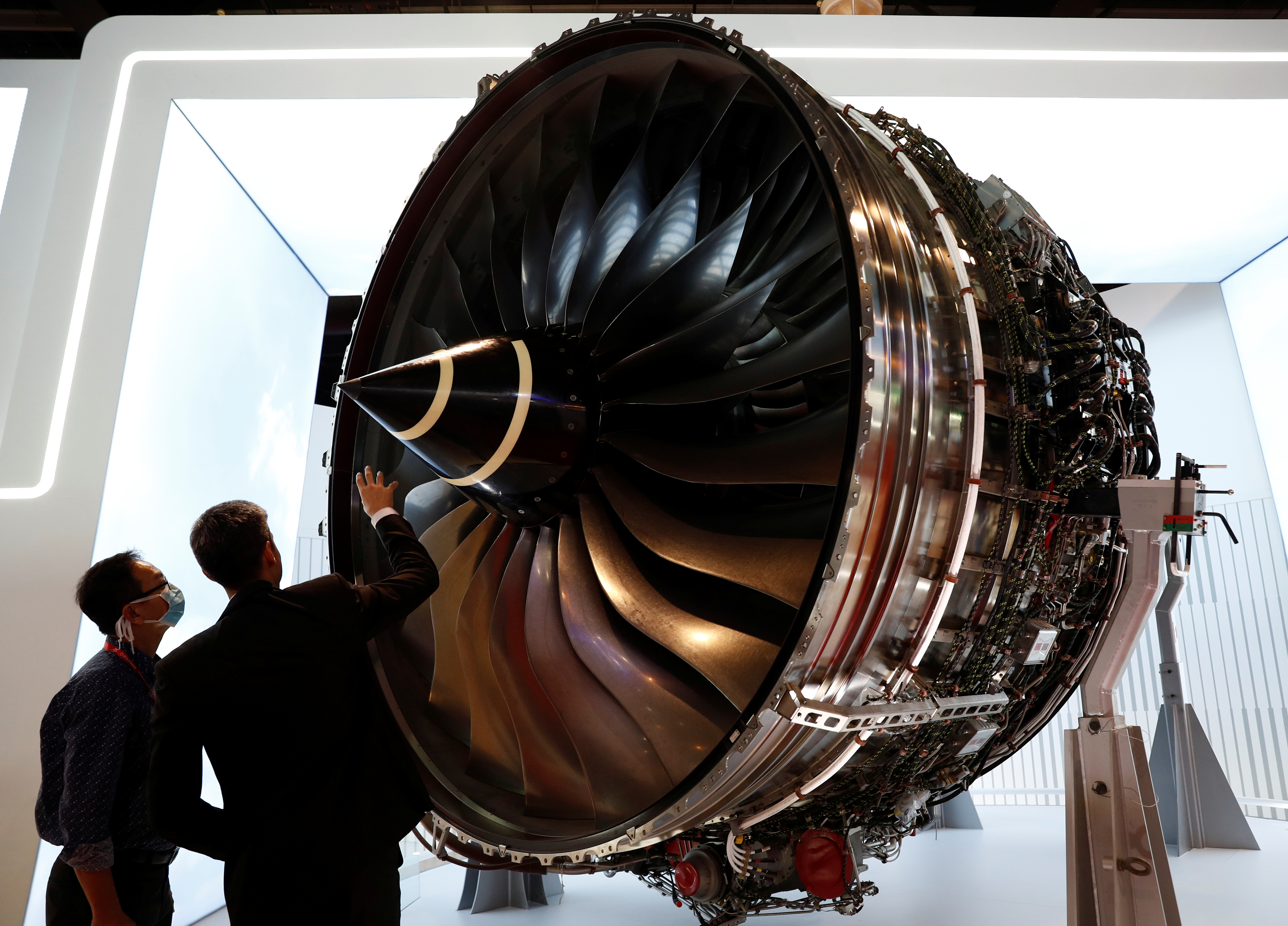 A man looks at Rolls Royce's Trent Engine displayed at the Singapore Airshow in Singapore