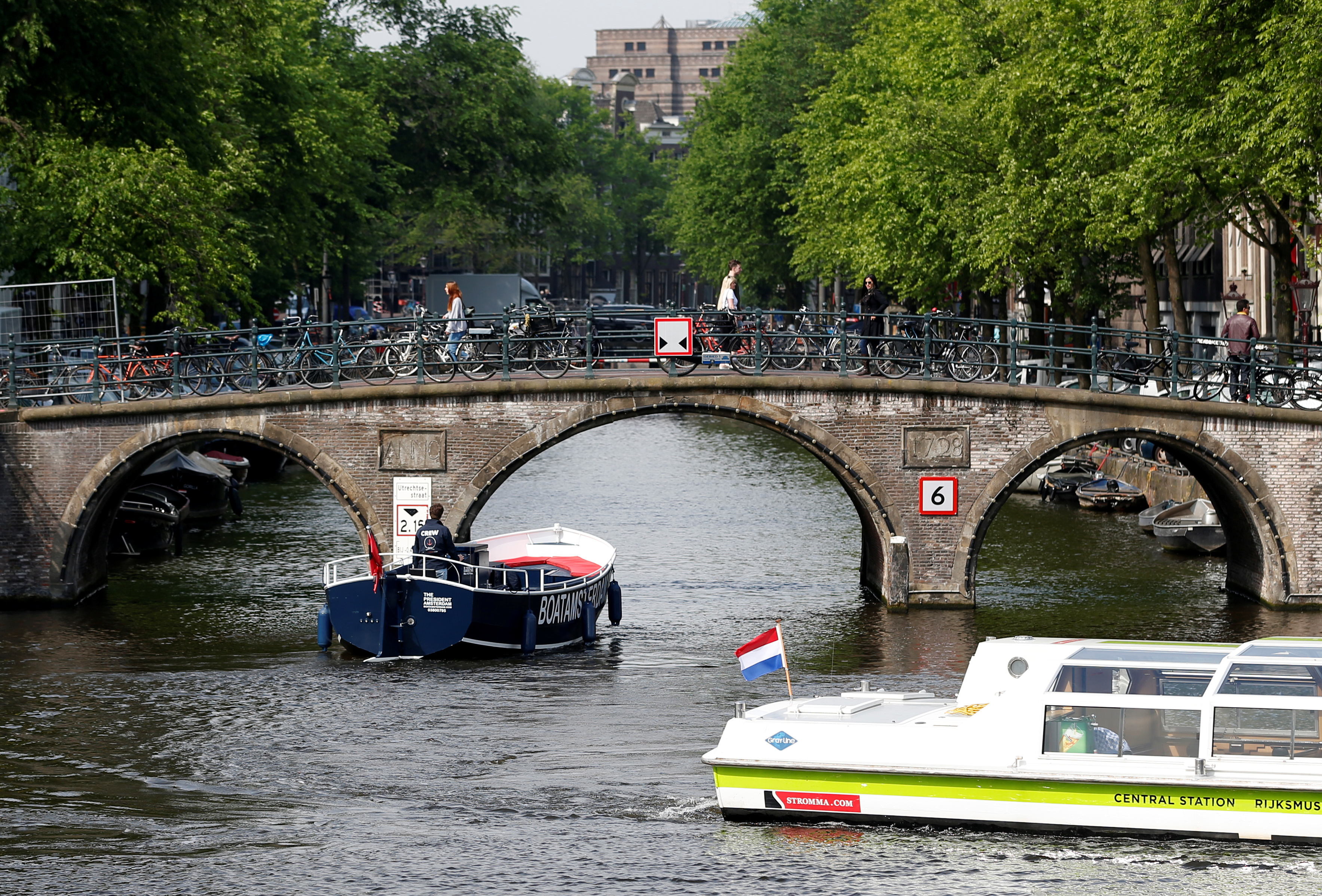 Tourists boats pass on a canal in Amsterdam