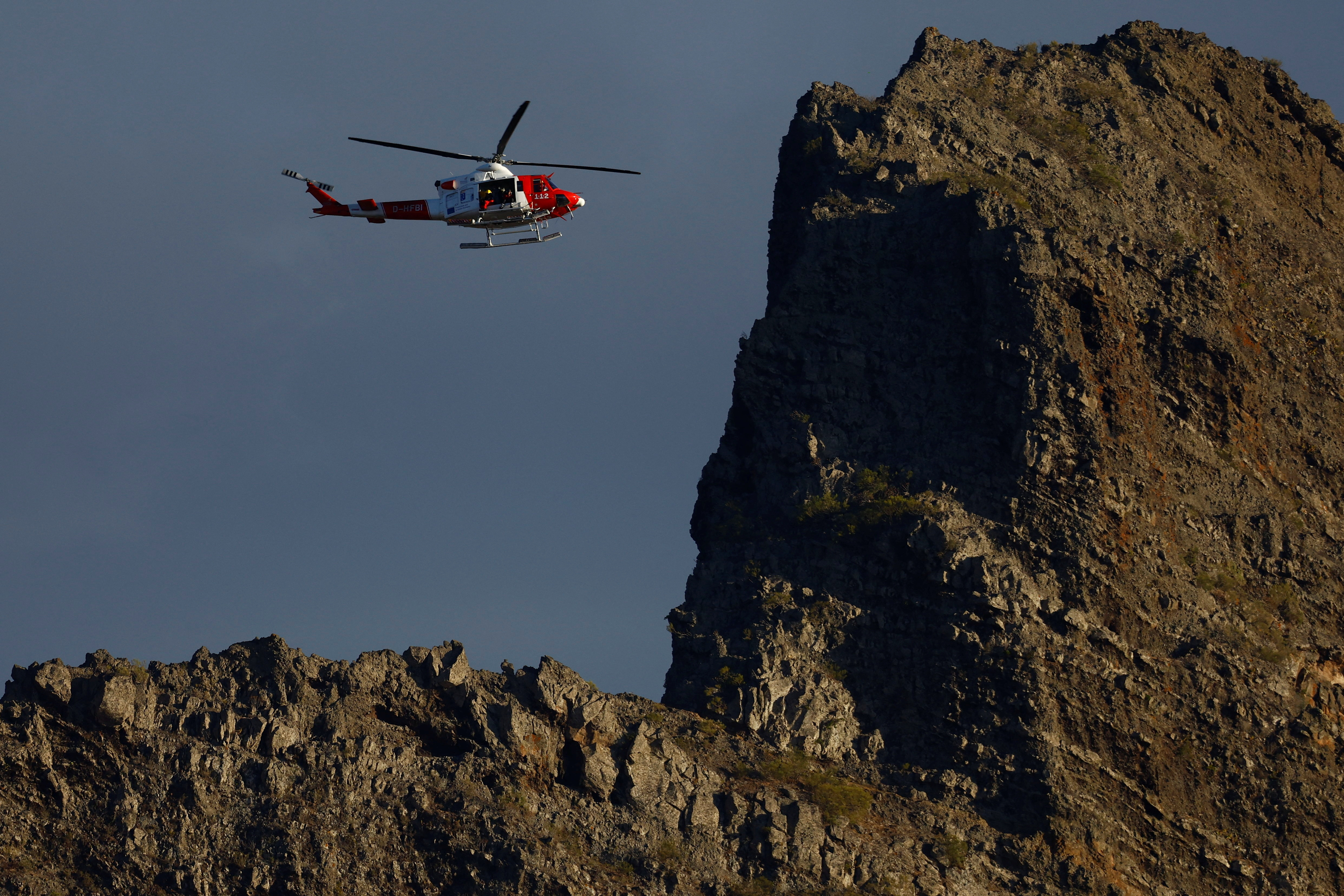 A rescue helicopter searches for a young British man who disappeared in the Masca ravine, on the island of Tenerife