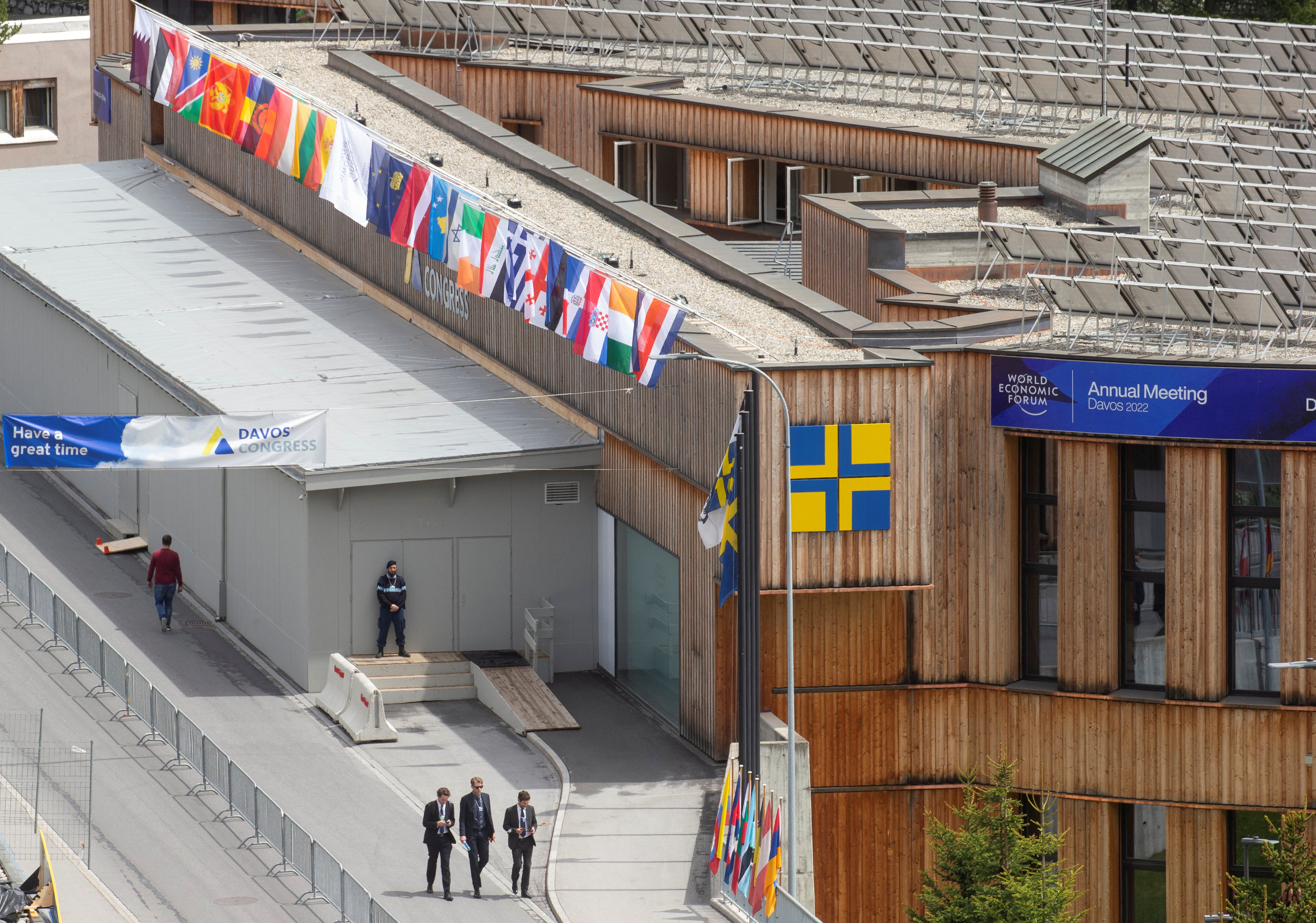 People walk past the congress center, the venue of the World Economic Forum 2022, in Davos