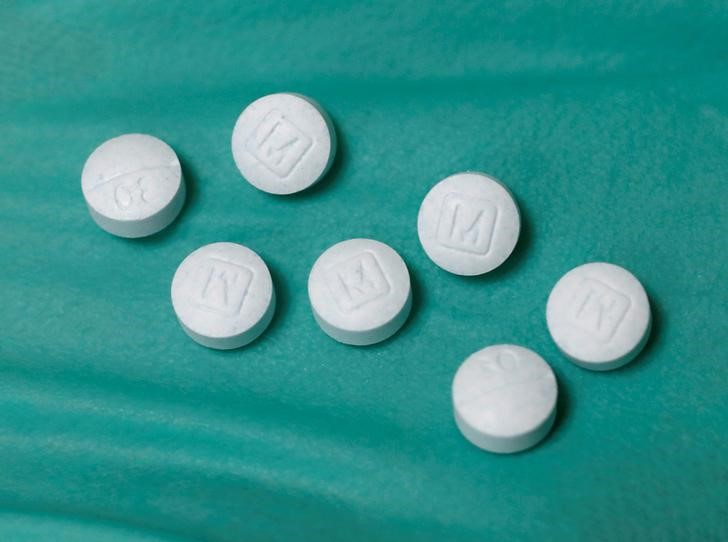 A pharmacist holds prescription painkiller Oxycodone Hydrochloride, 30mg pills, made by Mallinckrodt