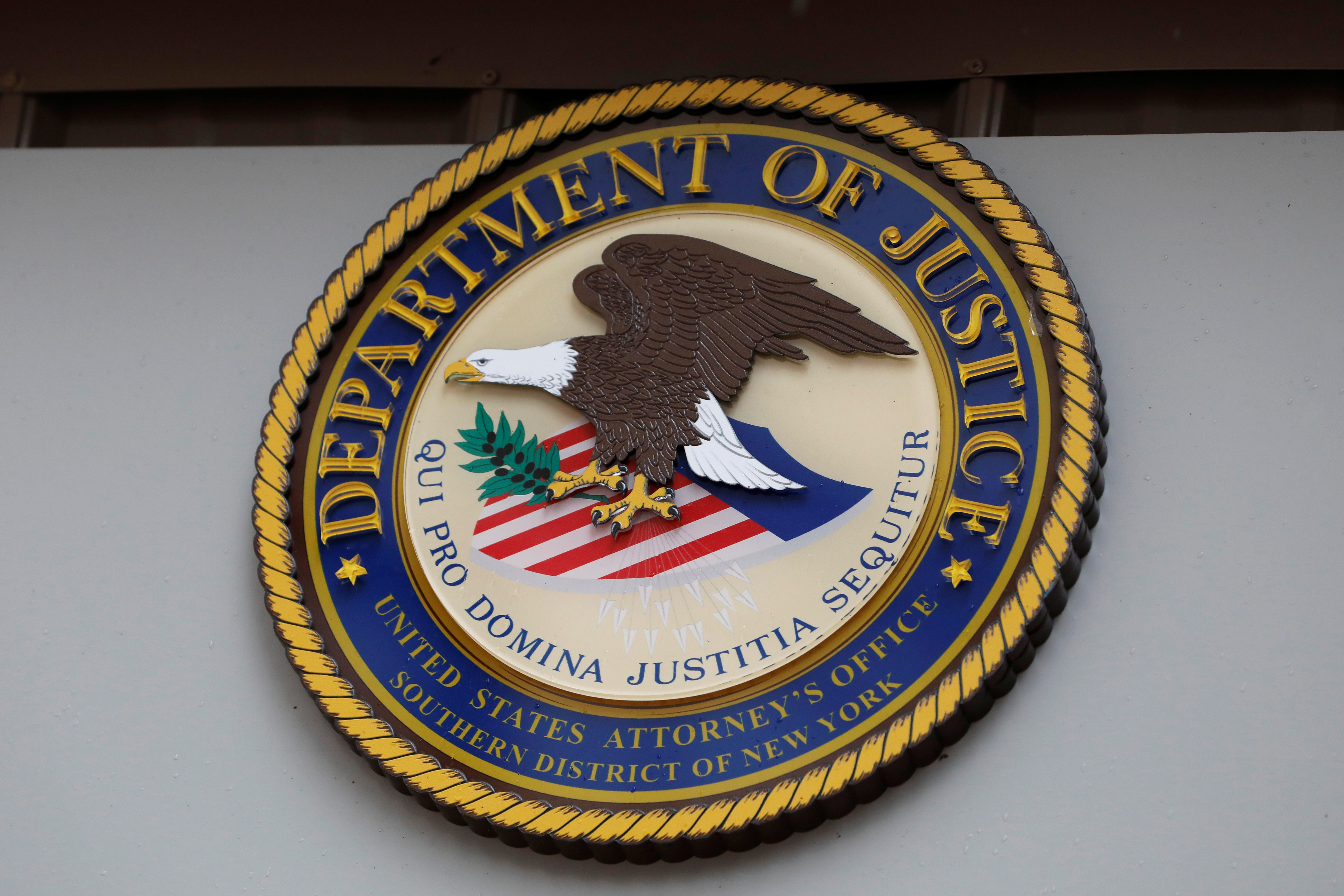 The seal of the United States Department of Justice is seen on the building exterior of the United States Attorney's Office of the Southern District of New York in Manhattan, New York City, U.S., August 17, 2020. REUTERS/Andrew Kelly/File Photo