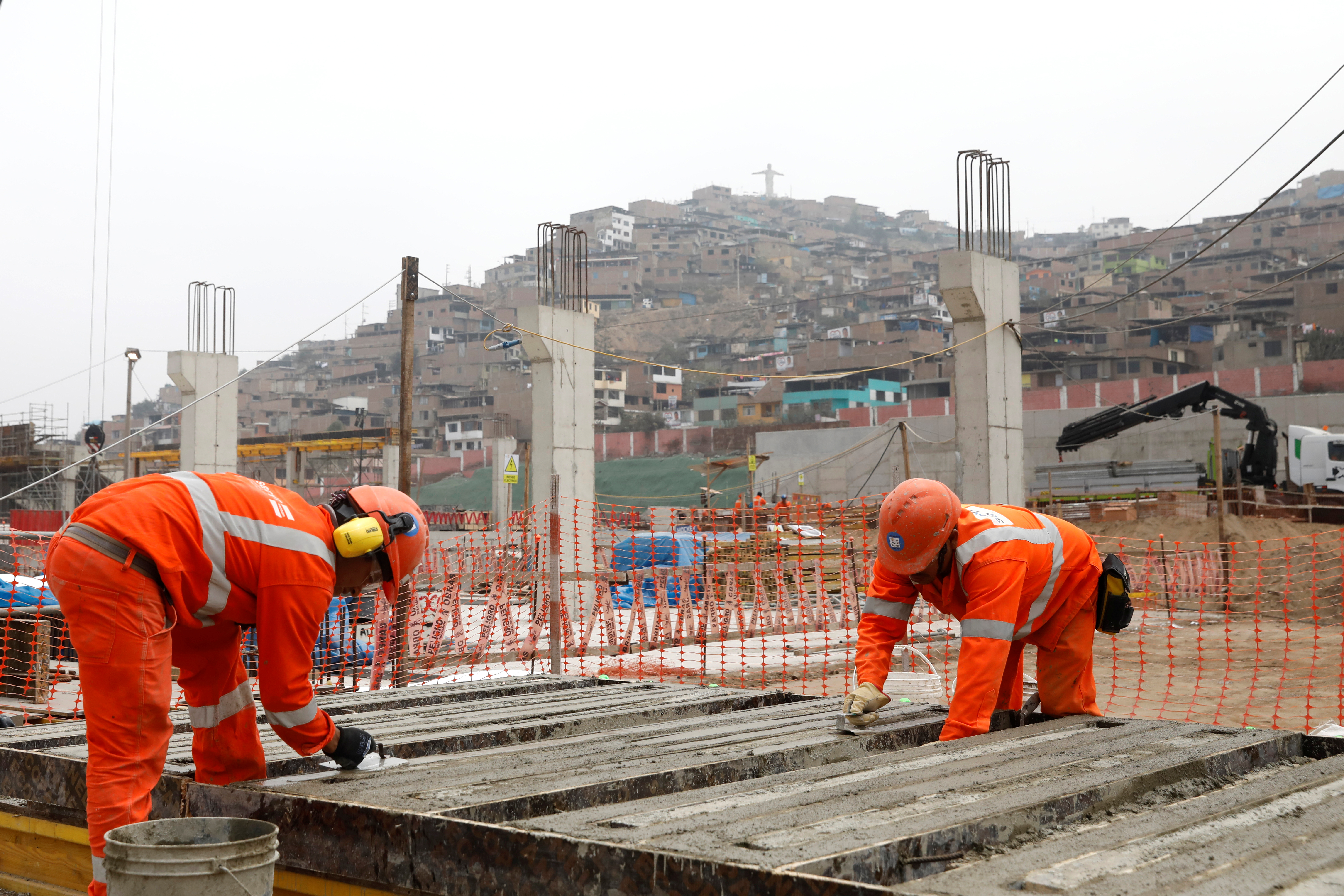 Houses are seen behind a construction site of the Pan American Games, in Lima