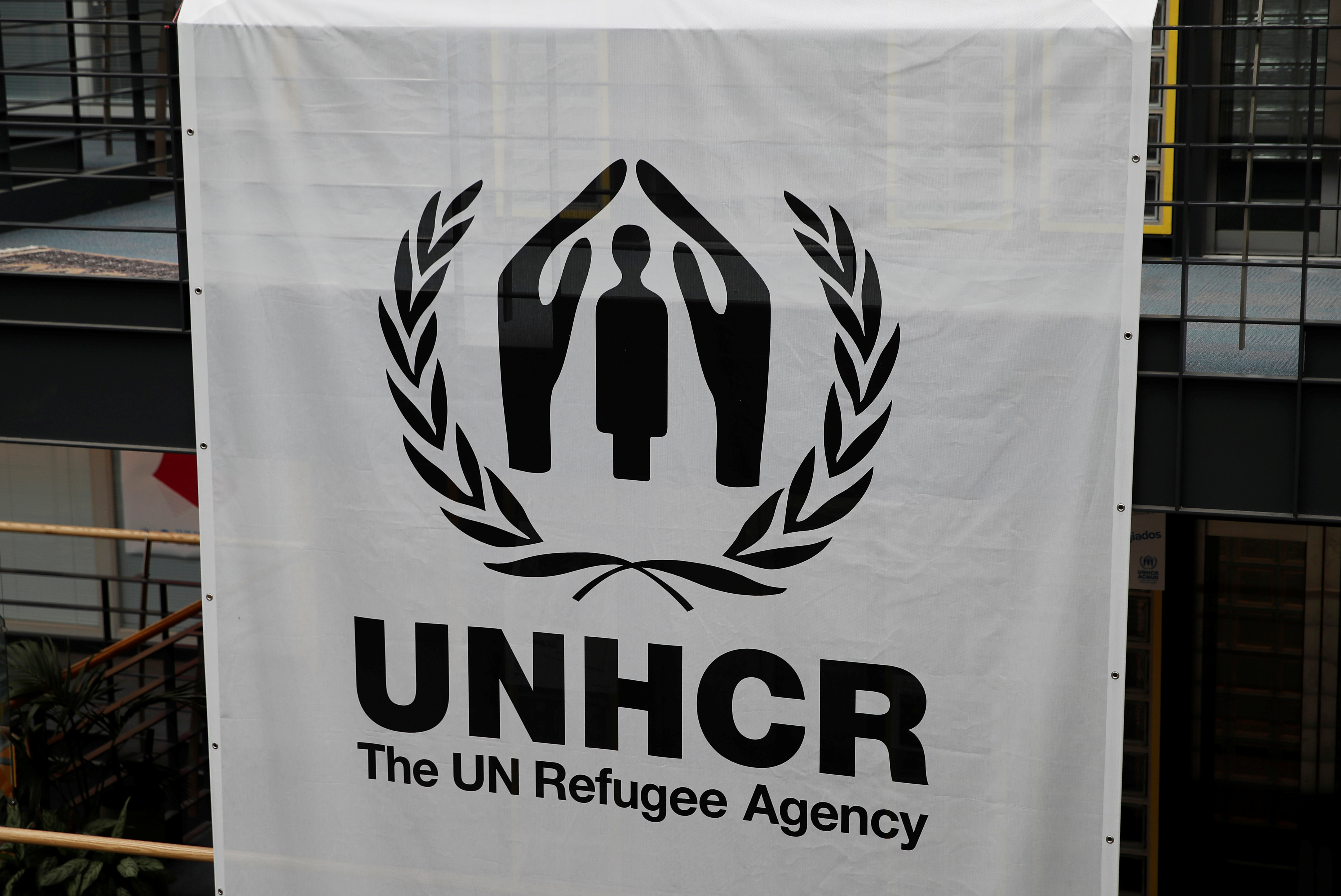 A logo is pictured on a banner at the UNHCR headquarters in Geneva