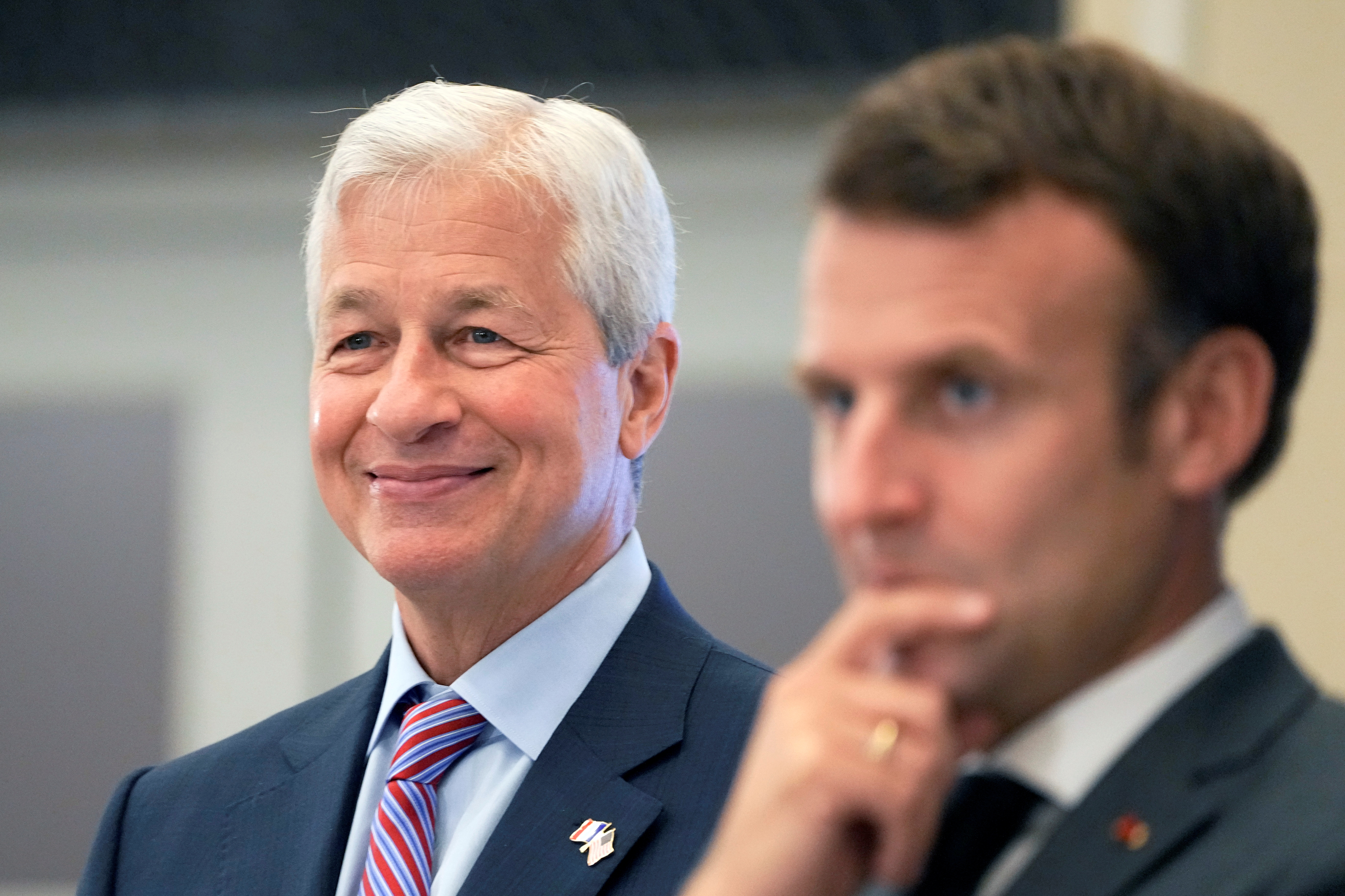 JP Morgan CEO Jamie Dimon and French President Emmanuel Macron listen as they inaugurate the new French headquarters of JP Morgan bank in Paris