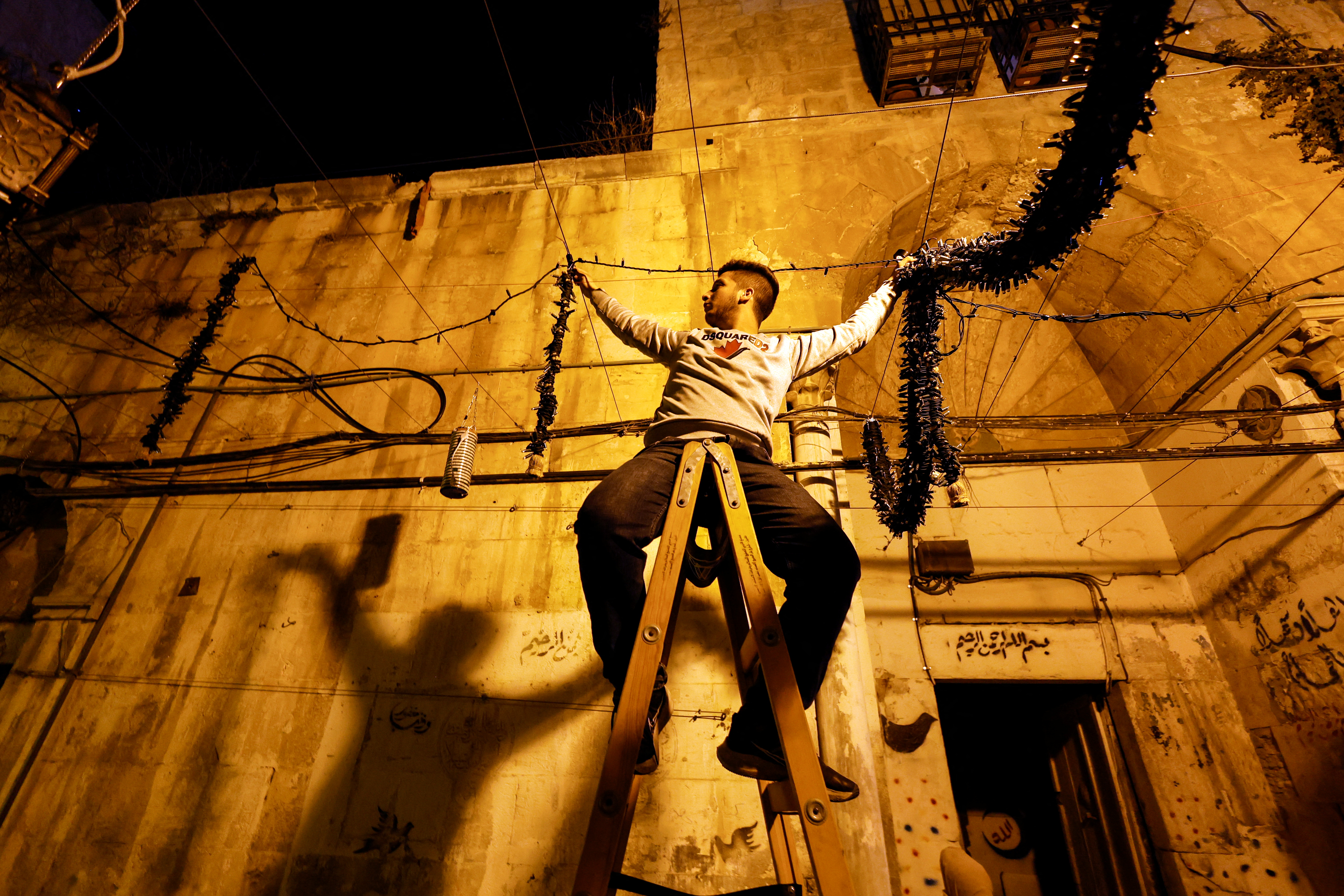 A man hangs decorations ahead of the holy month of Ramadan in Jerusalem's Old City