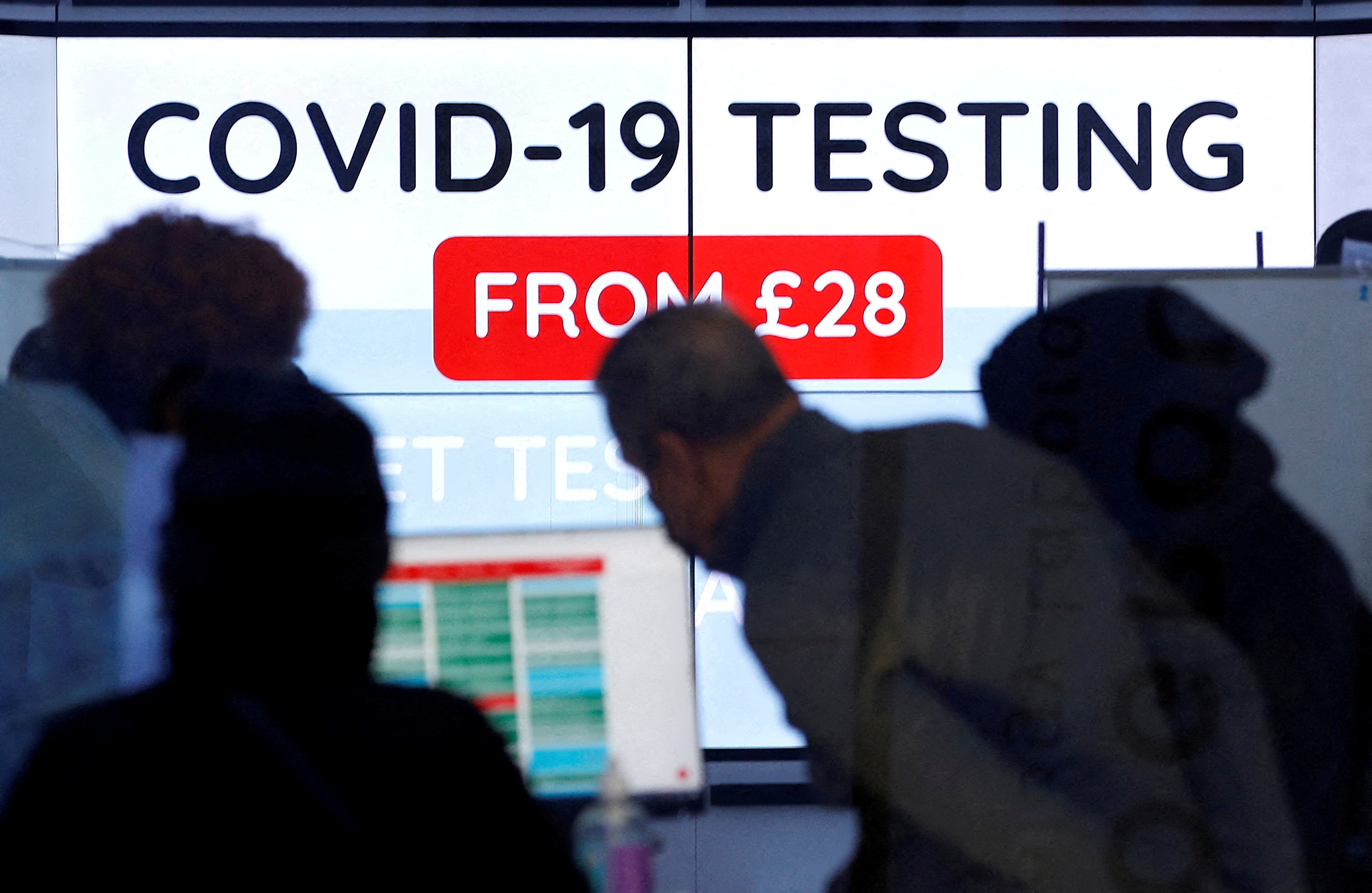 Customers are seen inside a private COVID-19 testing clinic in a busy shopping area, amid the coronavirus disease (COVID-19) outbreak in London