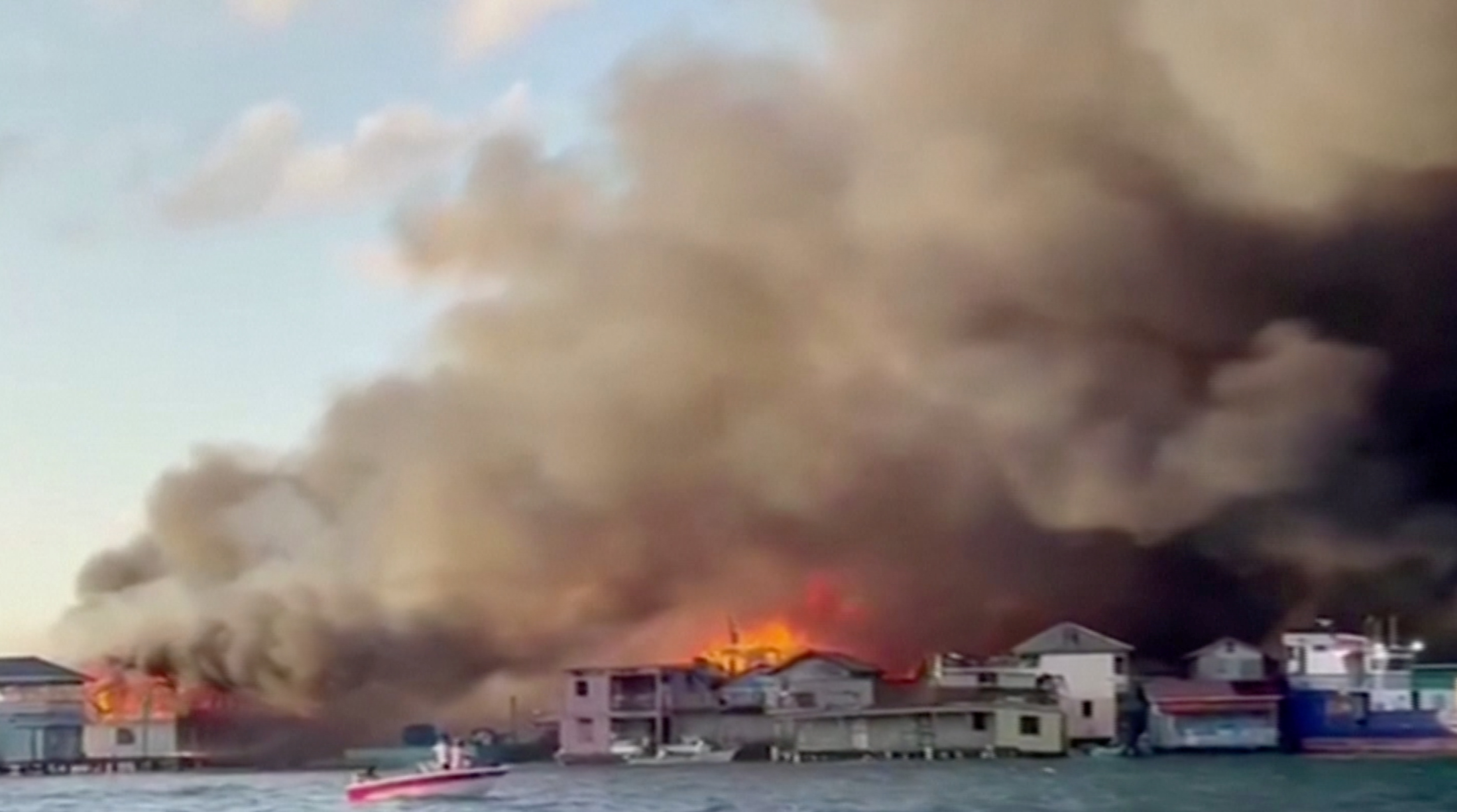 Smoke billows from a fire at a residential area on the island of Guanaja, Honduras in this screen grab taken from a video taken October 2, 2021. COPECO/Reuters TV via REUTERS 