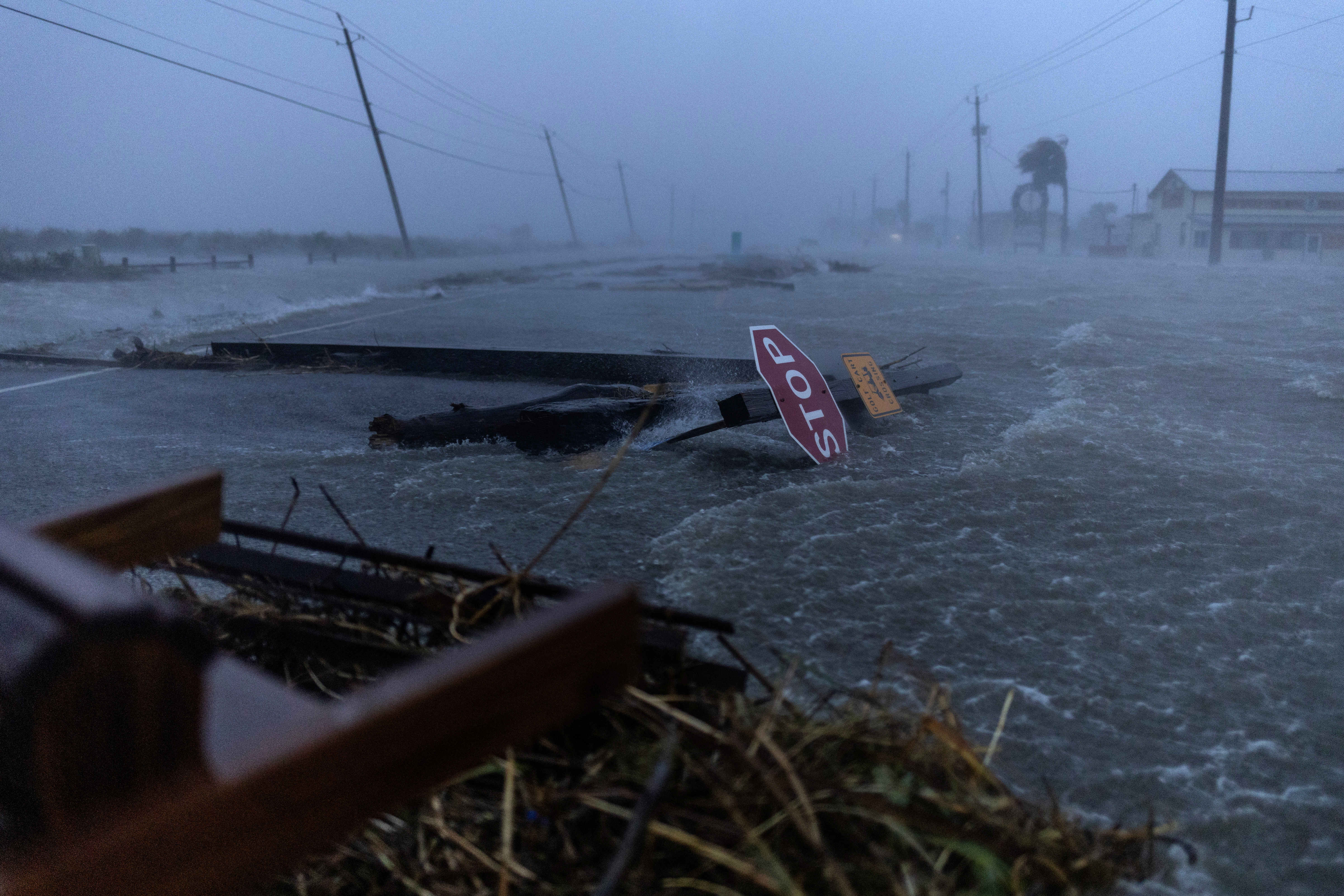 Debris and flood waters from Hurricane Beryl cover the main roadway in Surfside Beach, Texas
