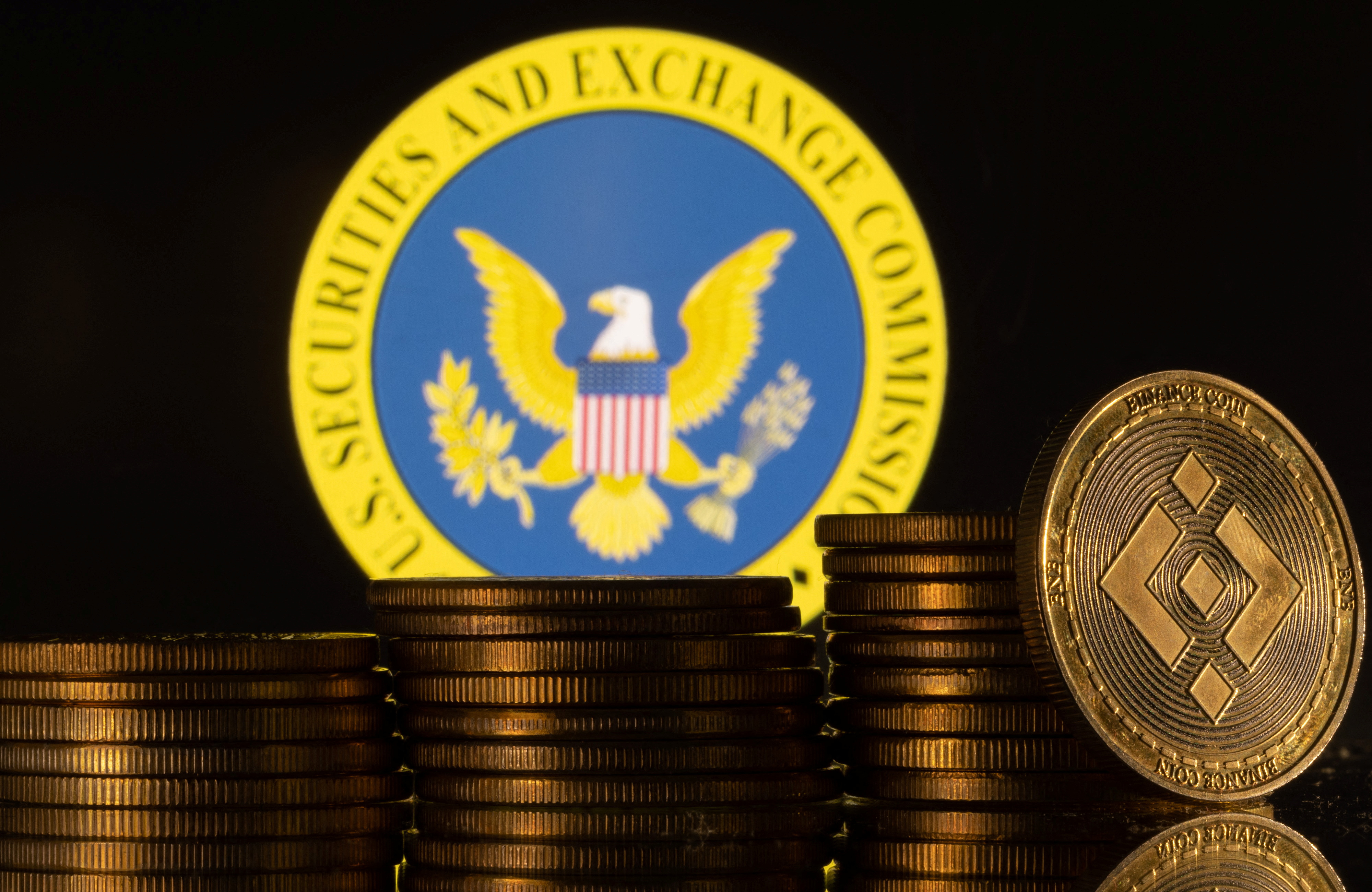 Illustration shows U.S. Securities and Exchange Commission logo and representations of cryptocurrency Binance