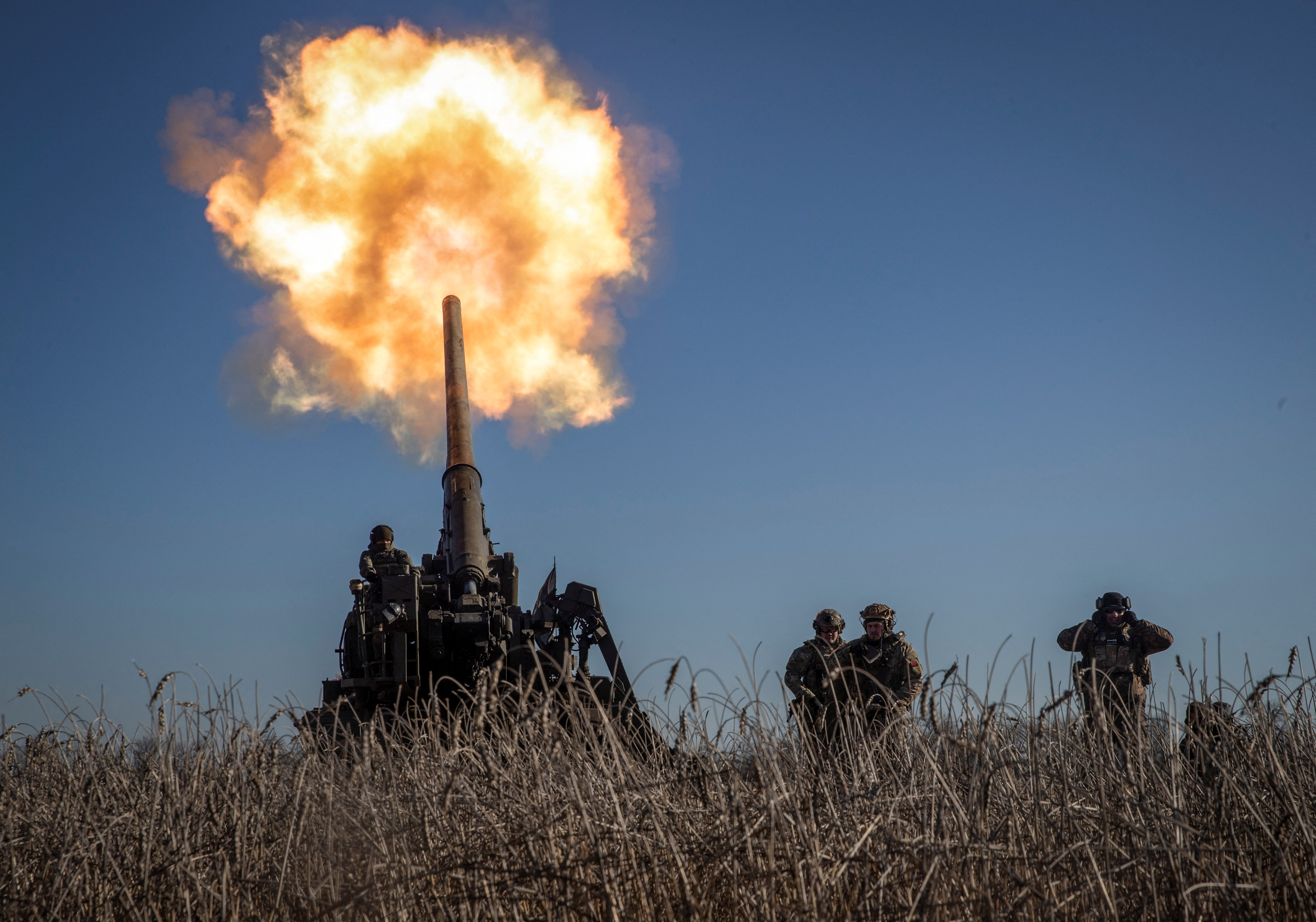 Ukrainian servicemen fire a 2S7 Pion self-propelled gun toward Russian positions on a frontline near Bakhmut