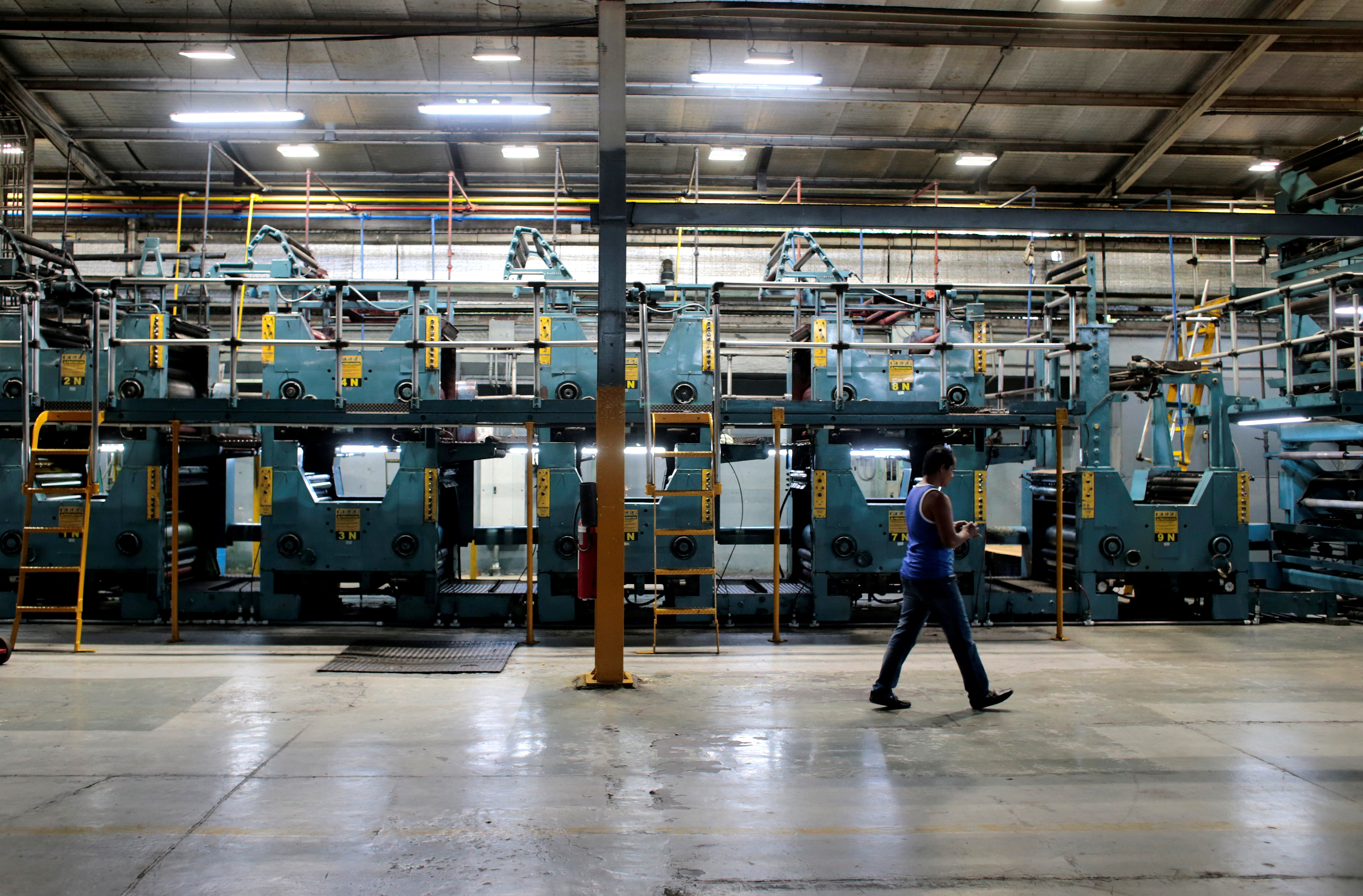 A worker walks inside of La Prensa newspaper printing plant in Managua