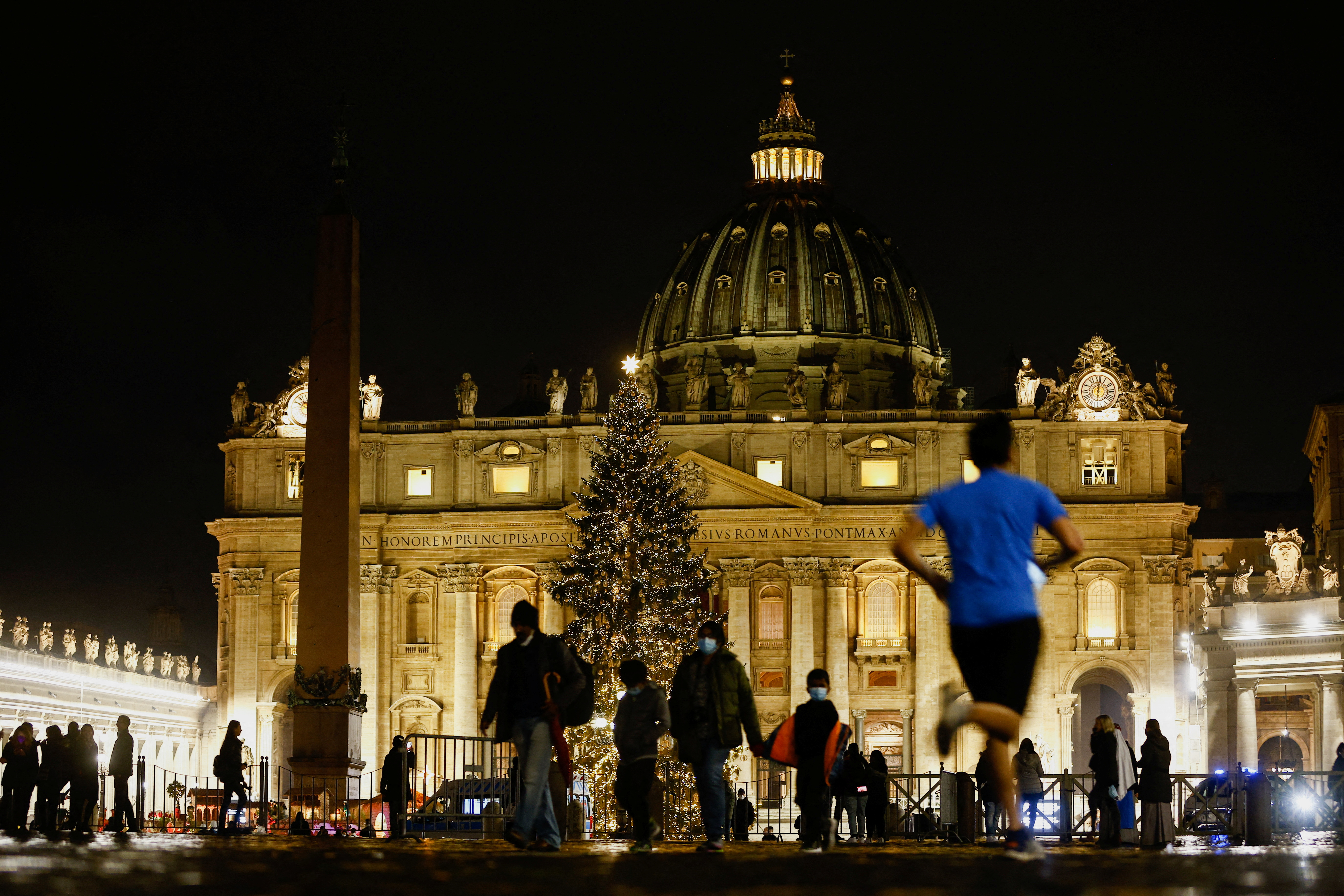 People gather in St. Peter's Square ahead of Christmas Eve mass celebrated by Pope Francis at the Vatican, December 24, 2021. REUTERS/Guglielmo Mangiapane