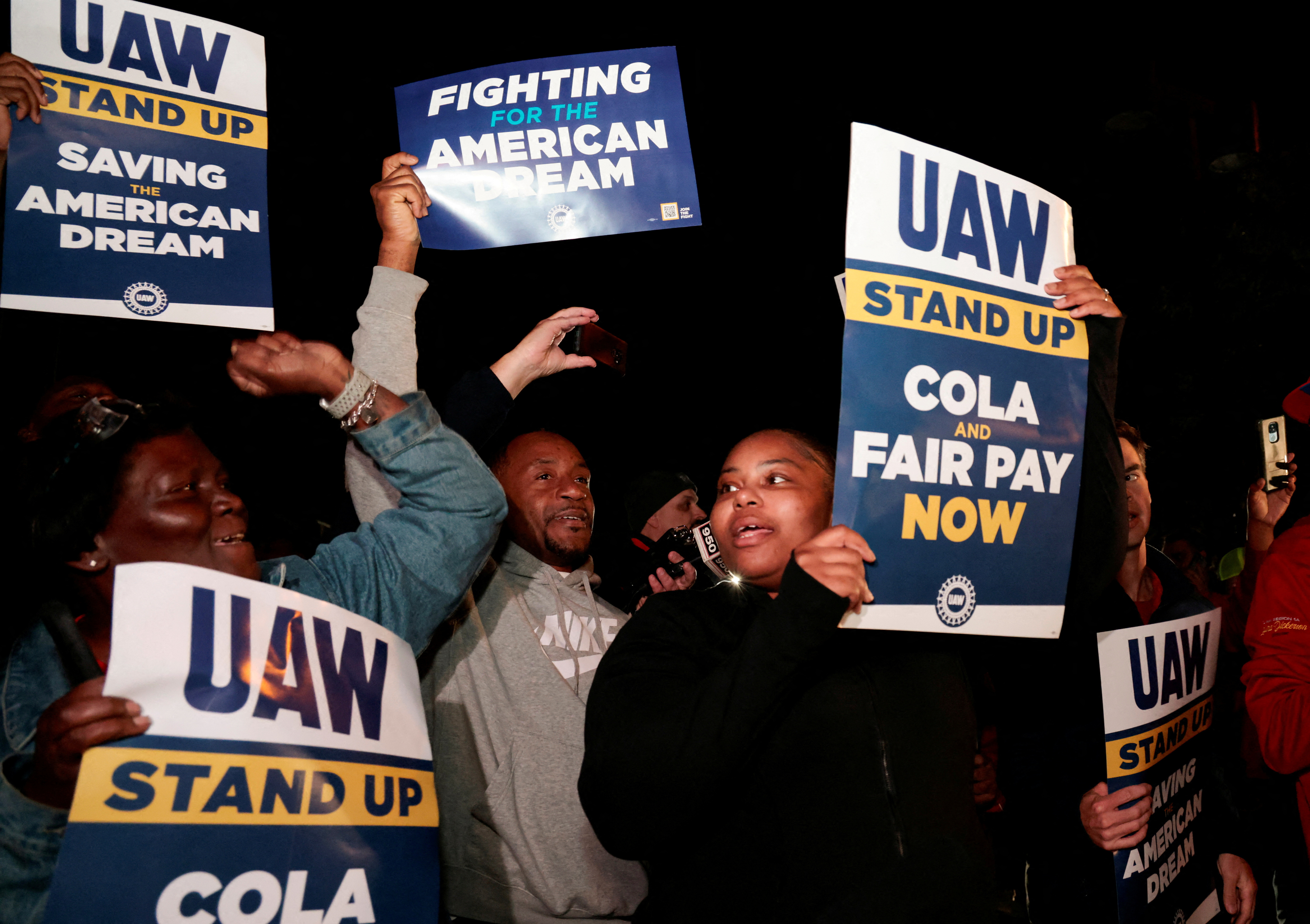 United Auto Workers members hold strike signs across from the Ford Michigan Assembly Plant in Wayne