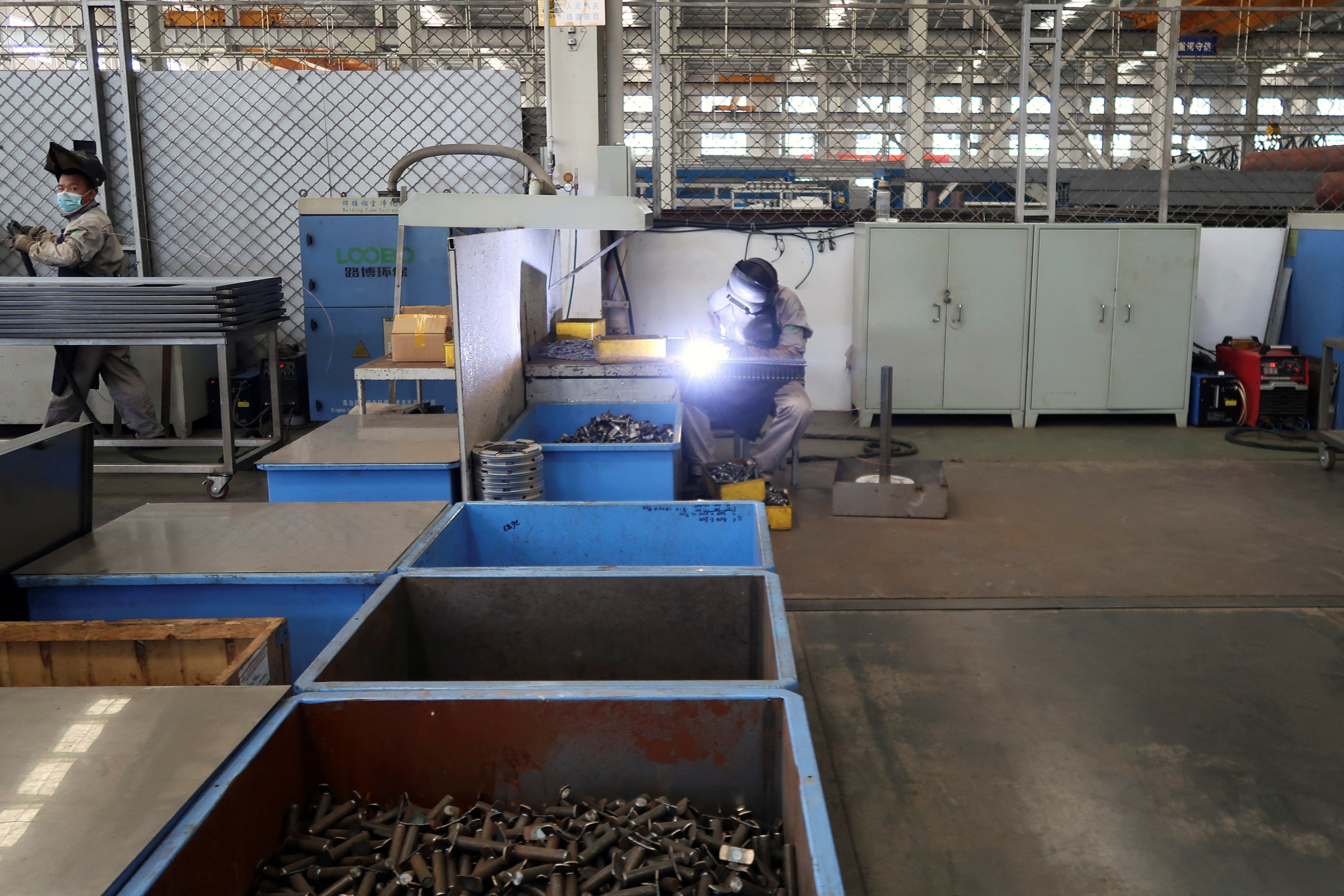 Employees work at Jingjin filter press factory in Dezhou