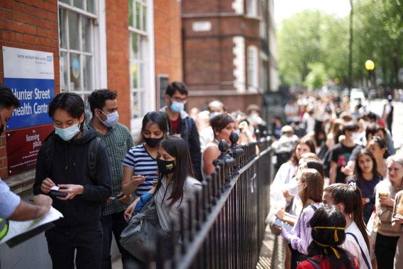 People queue outside a vaccination centre for young people and students at the Hunter Street Health Centre, amid the coronavirus disease (COVID-19) outbreak, in London, Britain, June 5, 2021. REUTERS/Henry Nicholls