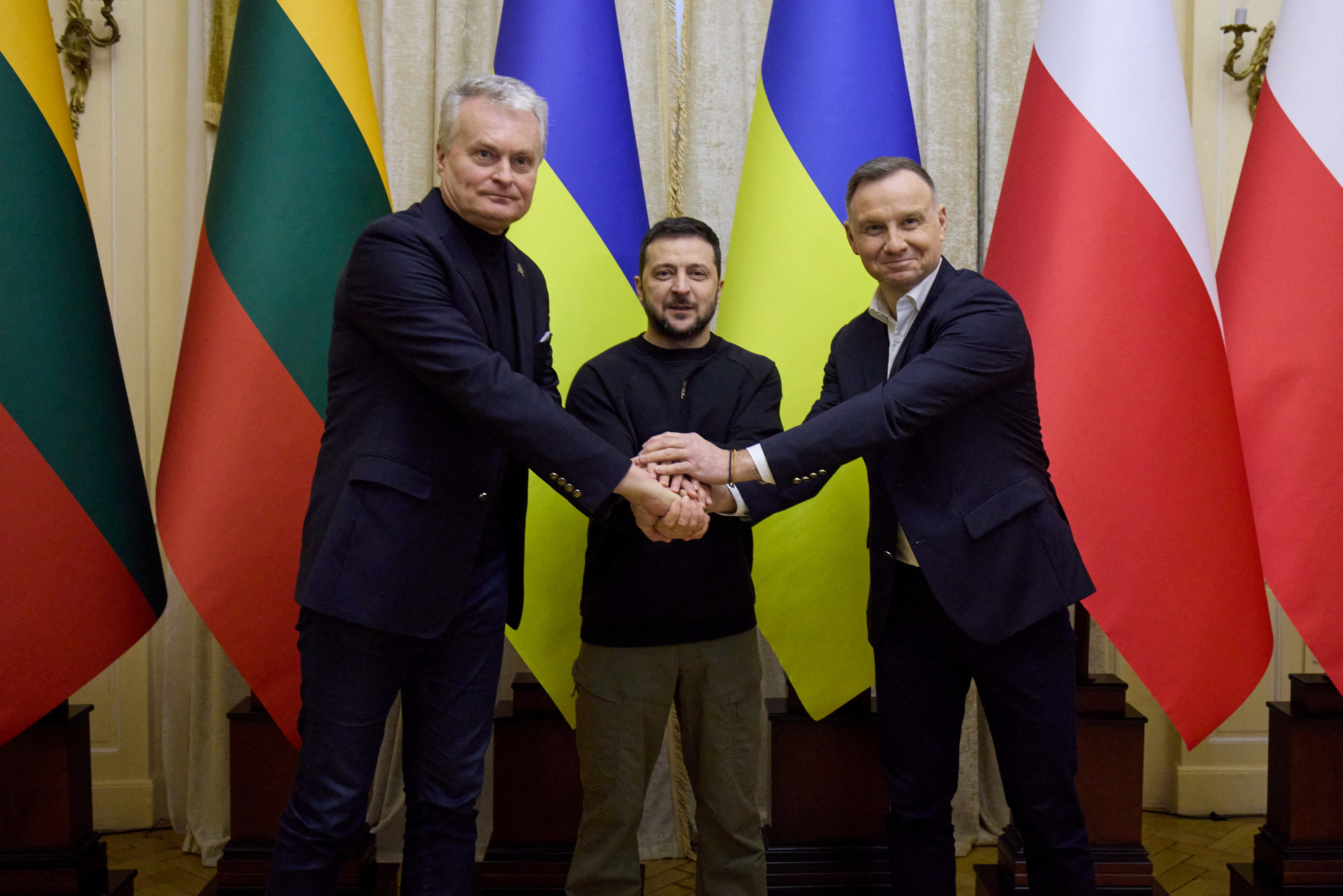 Ukraine's President Volodymyr Zelenskiy, Poland's President Duda and Lithuanian President Nauseda shake hands meeting in Lviv