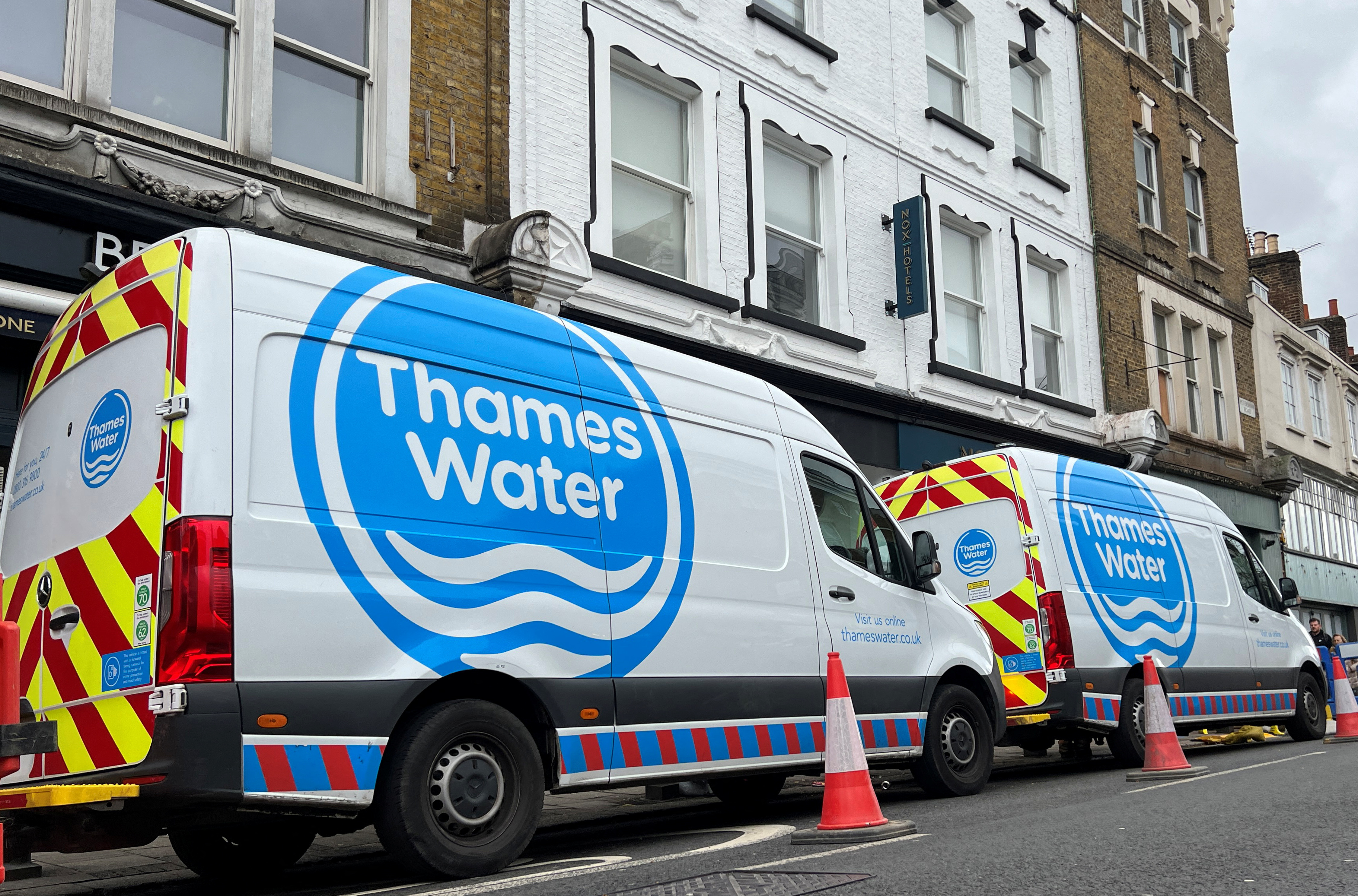 Thames Water vans are parked as repair and maintenance work takes place, in London