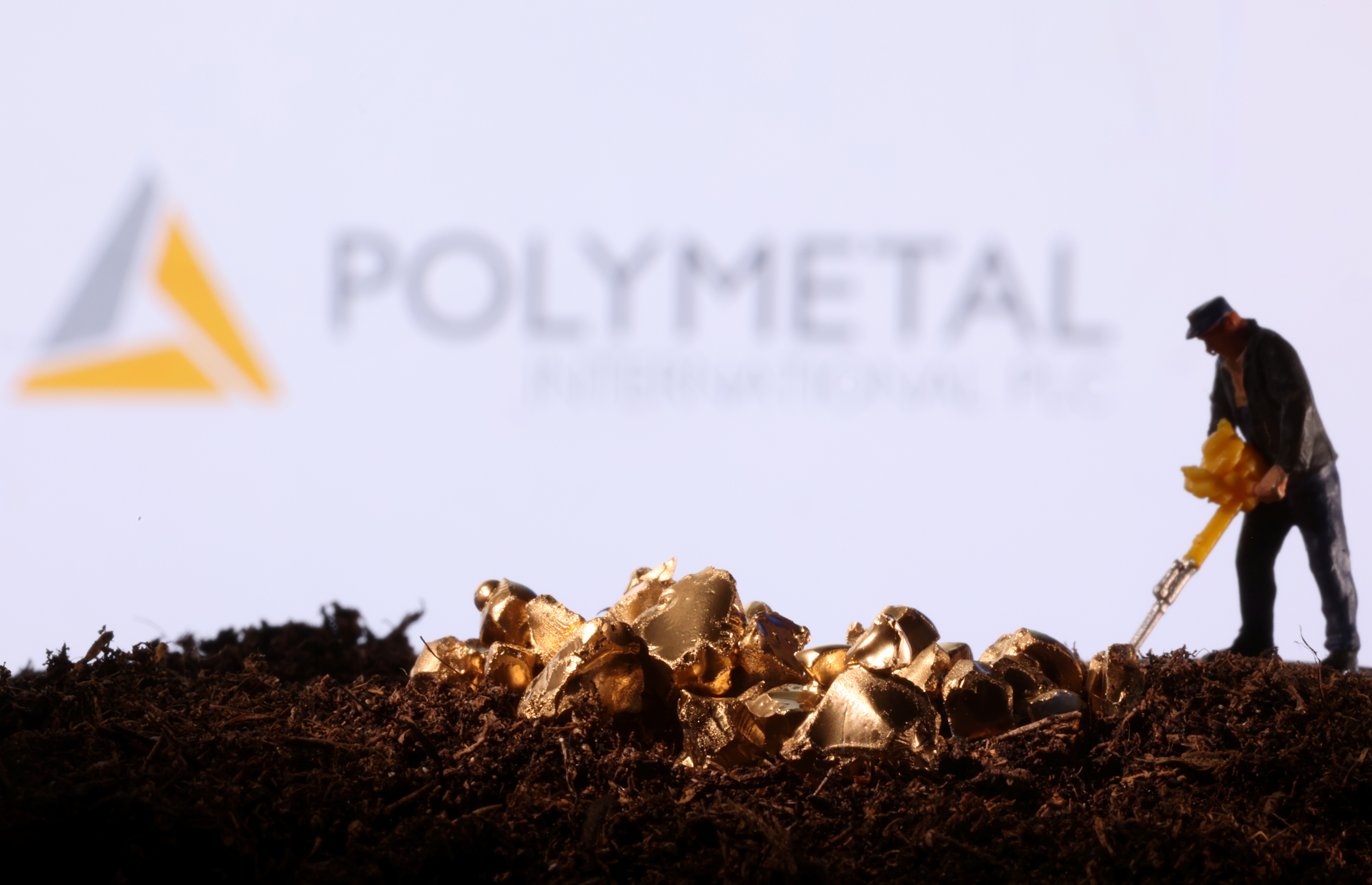 Small toy figure and gold imitation are seen in front of the Polymetal logo in this illustration
