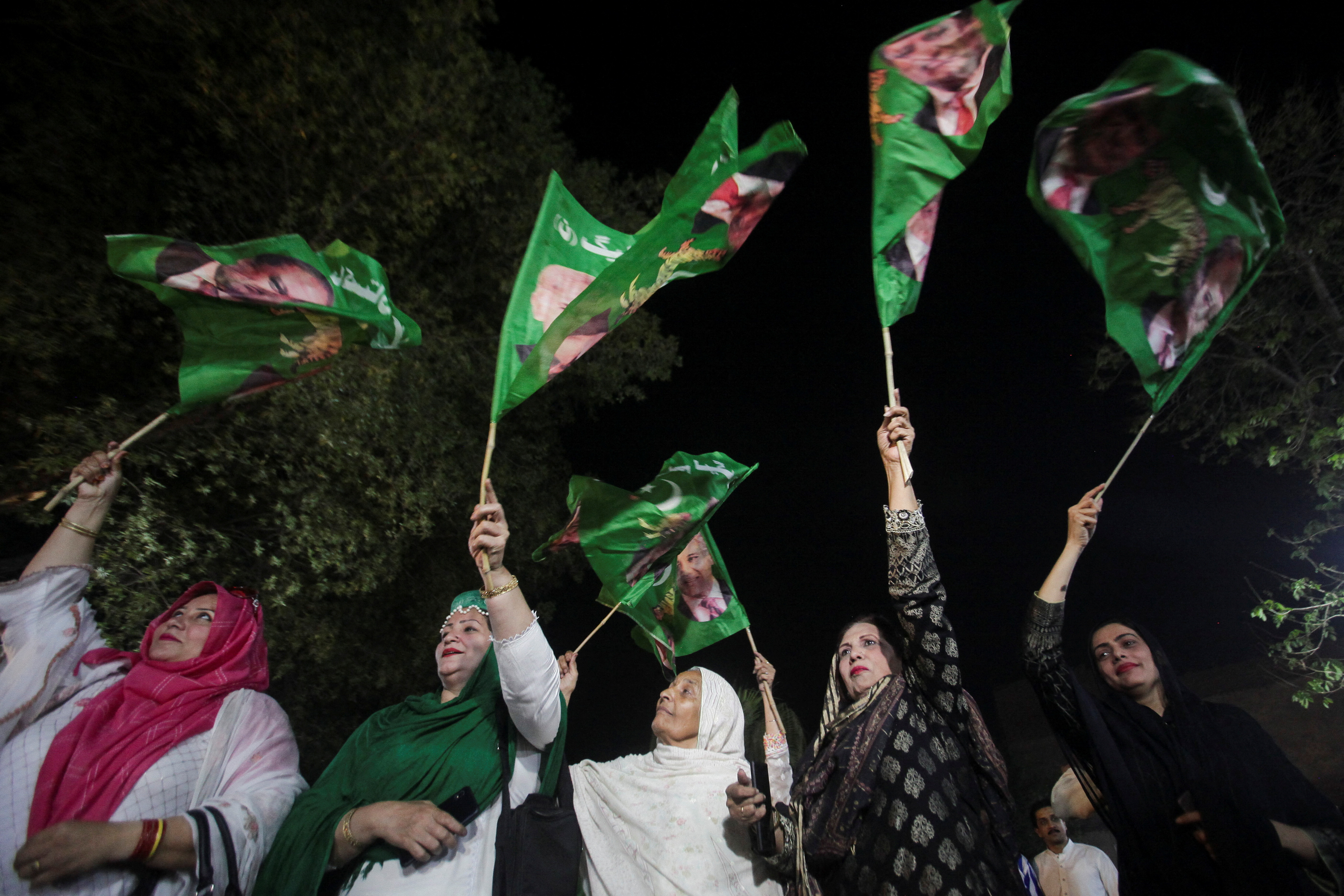 People celebrate after Shehbaz Sharif was sworn in as the country's prime minister, in Lahore,