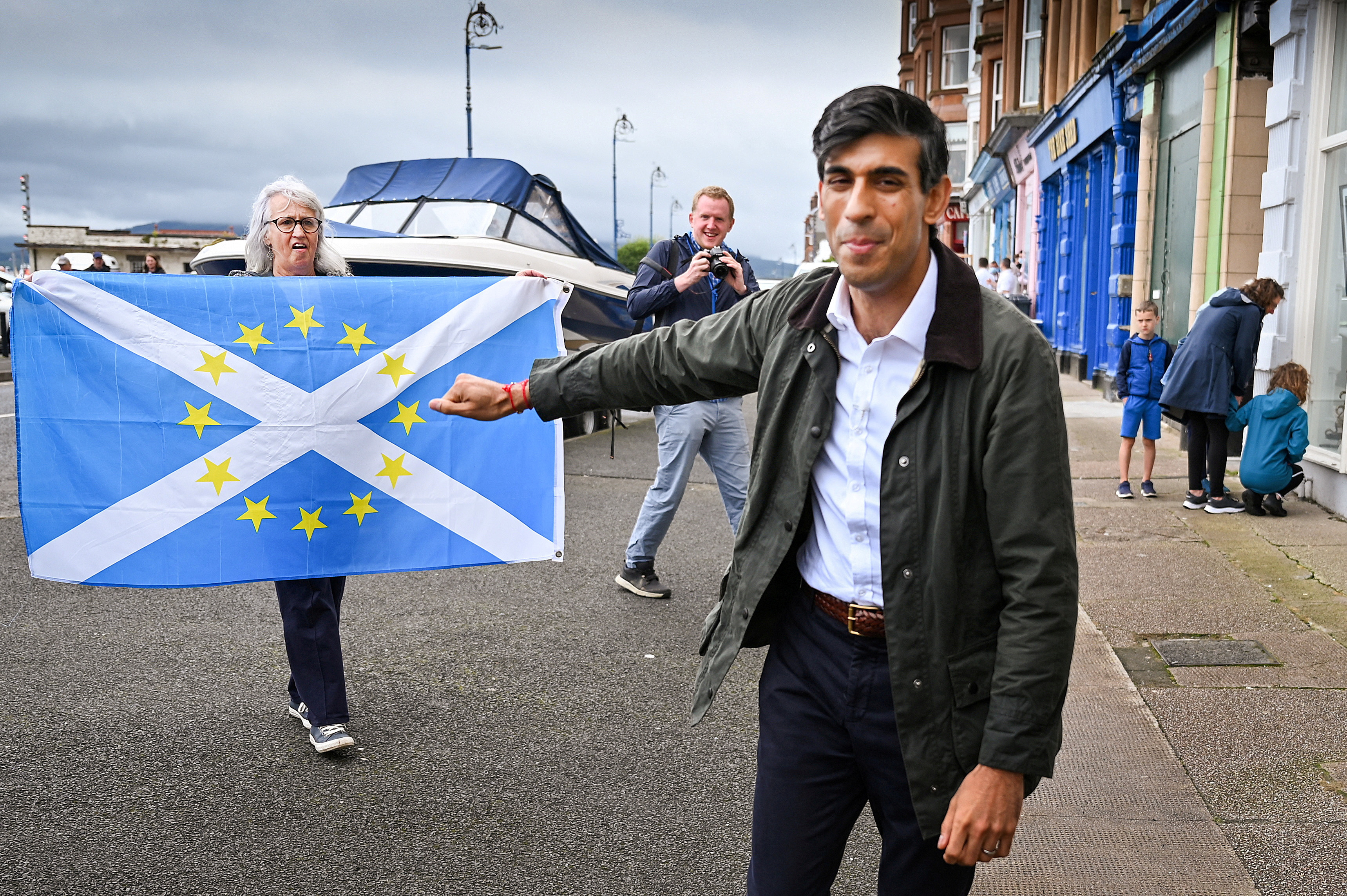 Nationalist demonstrators welcome Britain's Chancellor of the Exchequer Rishi Sunak in Rothesay