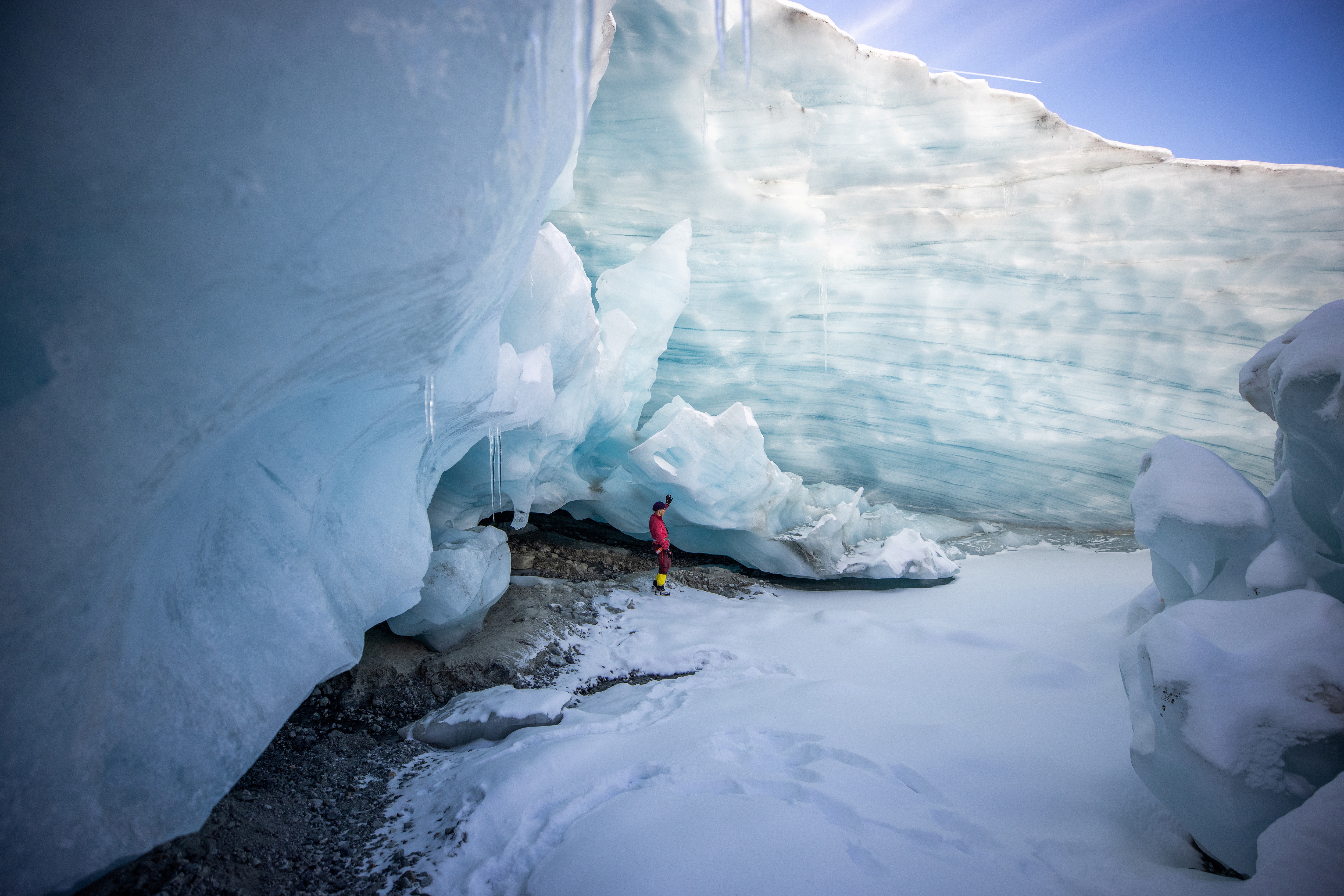 Glaciologist Andrea Fischer, from the Austrian Academy of Sciences, stands at the entrance of a natural glacier cavity of the Jamtalferner glacier near Galtuer, Austria, October 15, 2021. Giant ice caves have appeared in glaciers accelerating the melting process faster than expected as warmer air rushes through the ice mass until it collapses. Picture taken October 15, 2021. REUTERS/Lisi Niesner