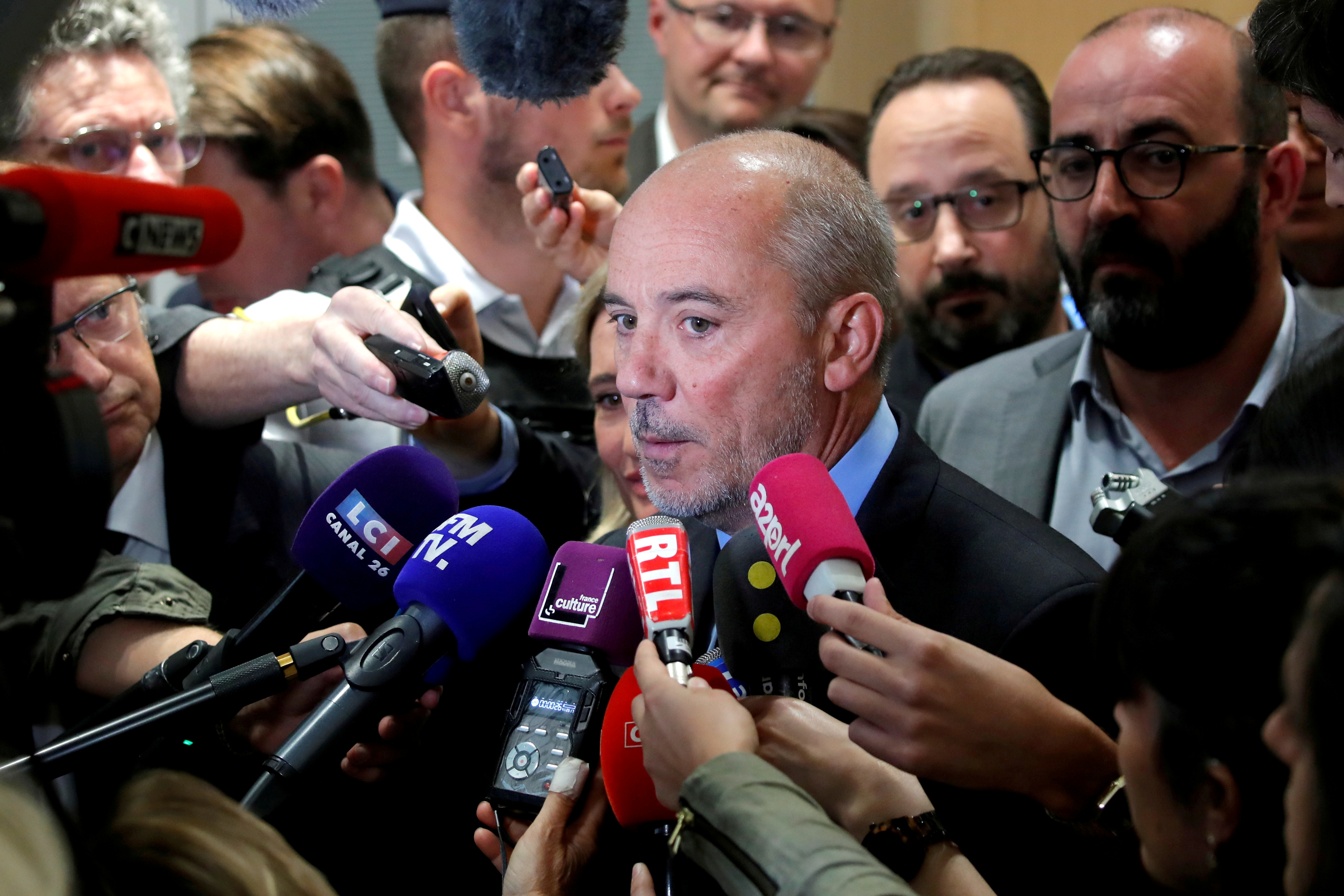 Orange chief executive Stephane Richard speaks to reporters inside the courthouse in Paris