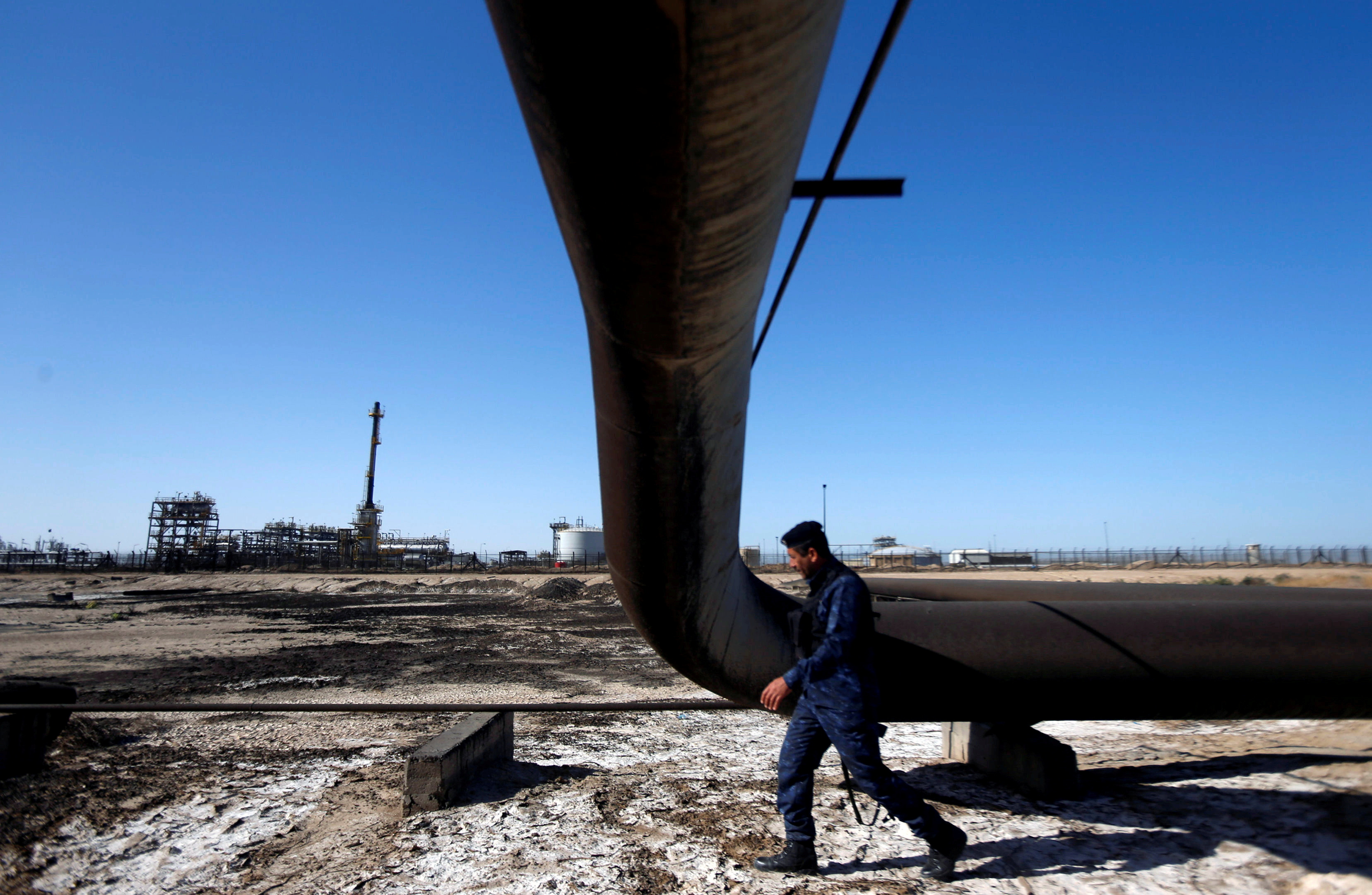 A policeman walks at West Qurna-1 oil field, which is operated by ExxonMobil, in Basra