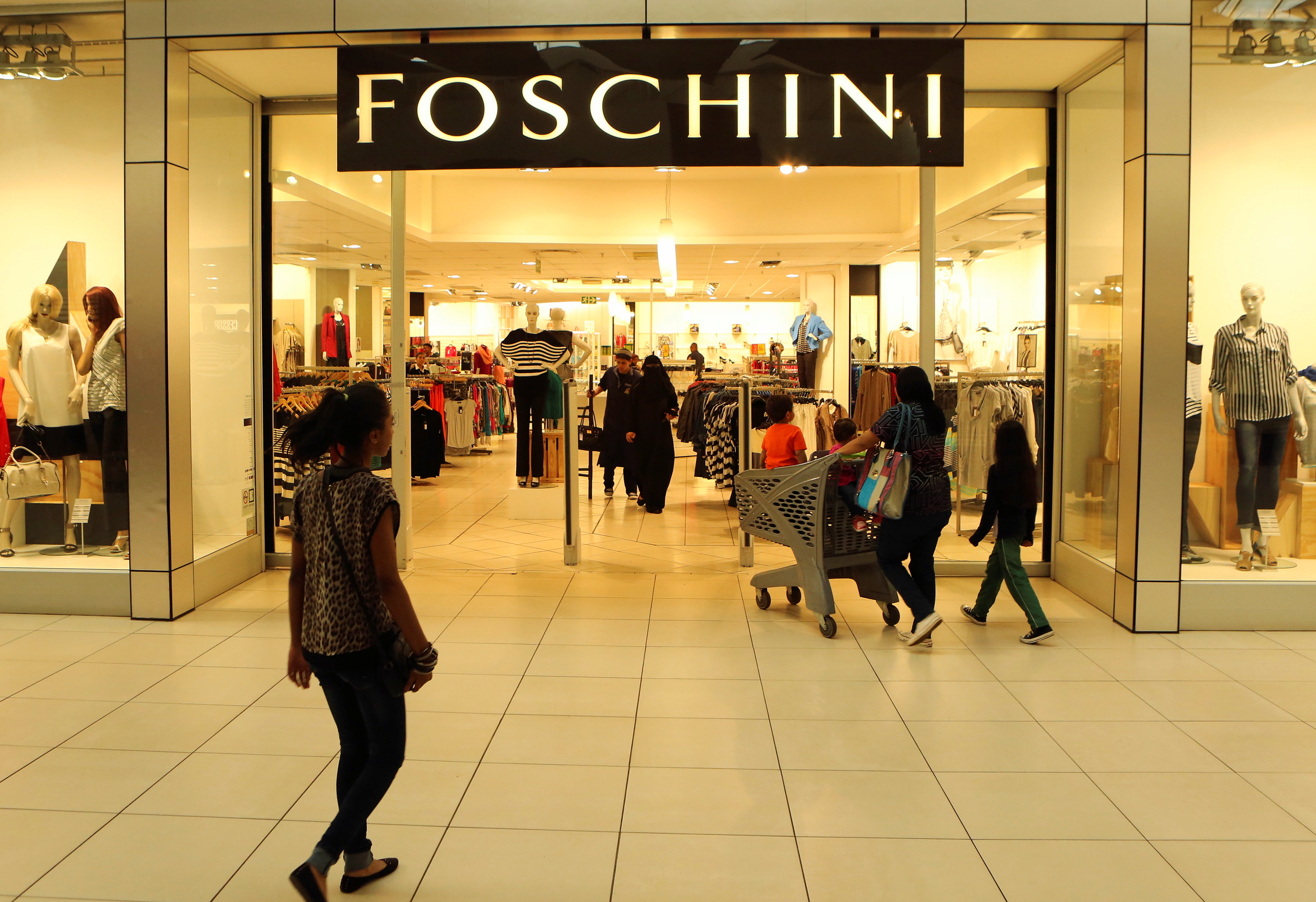 A shopper walks past a Foschini store at a shopping centre in Lenasia, south of Johannesburg