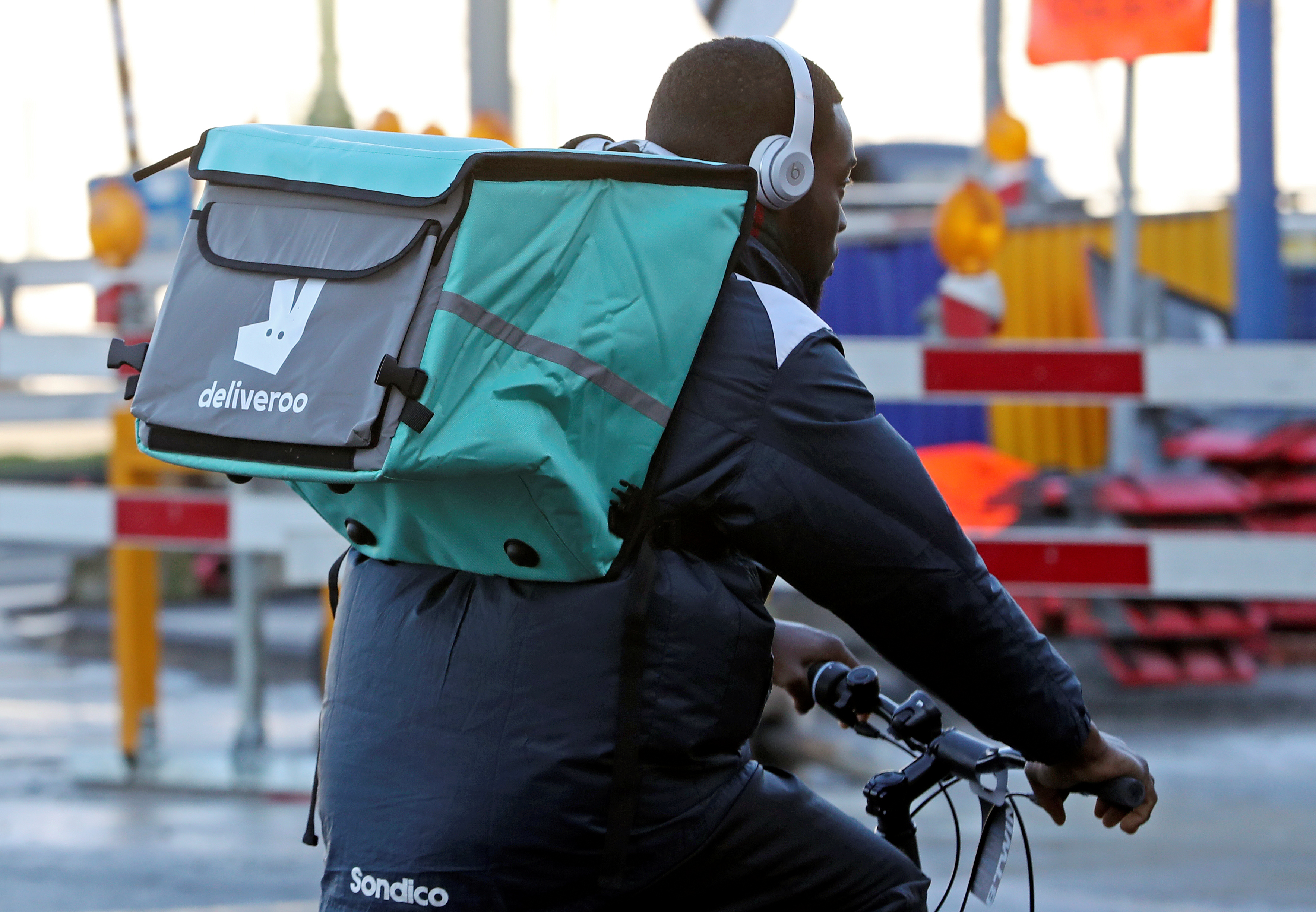 A courier for food delivery service Deliveroo rides a bike in central Brussels