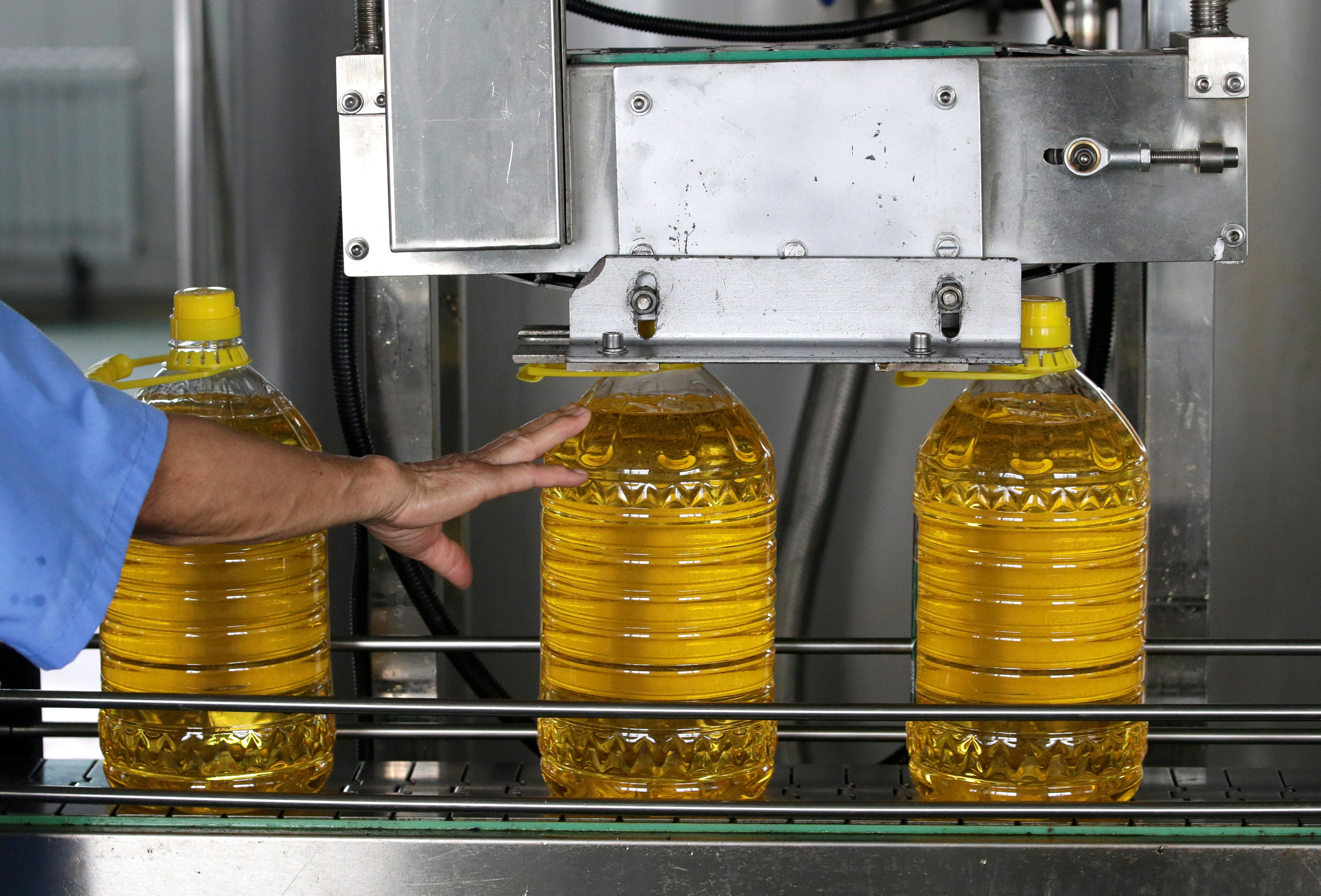 Bottles are filled with soybean oil made from the U.S. imported soybeans on a production line at a plant of Liangyou Industry and Trade Co., Ltd in Qufu