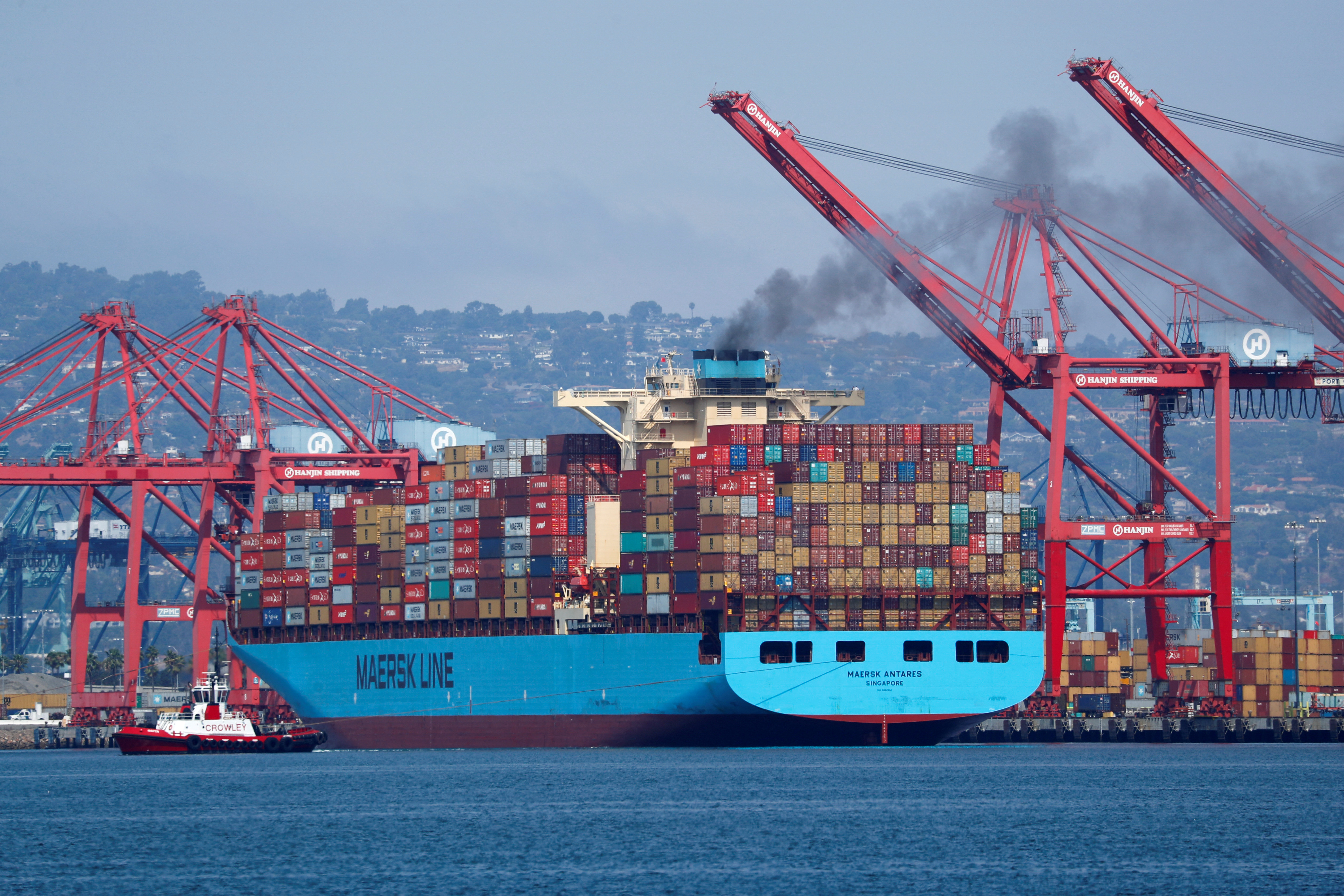 A Maersk Line container ship prepares to depart port in Long Beach, California