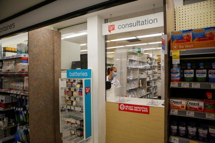 People are inoculated against coronavirus disease at a Walgreens store in Chicago