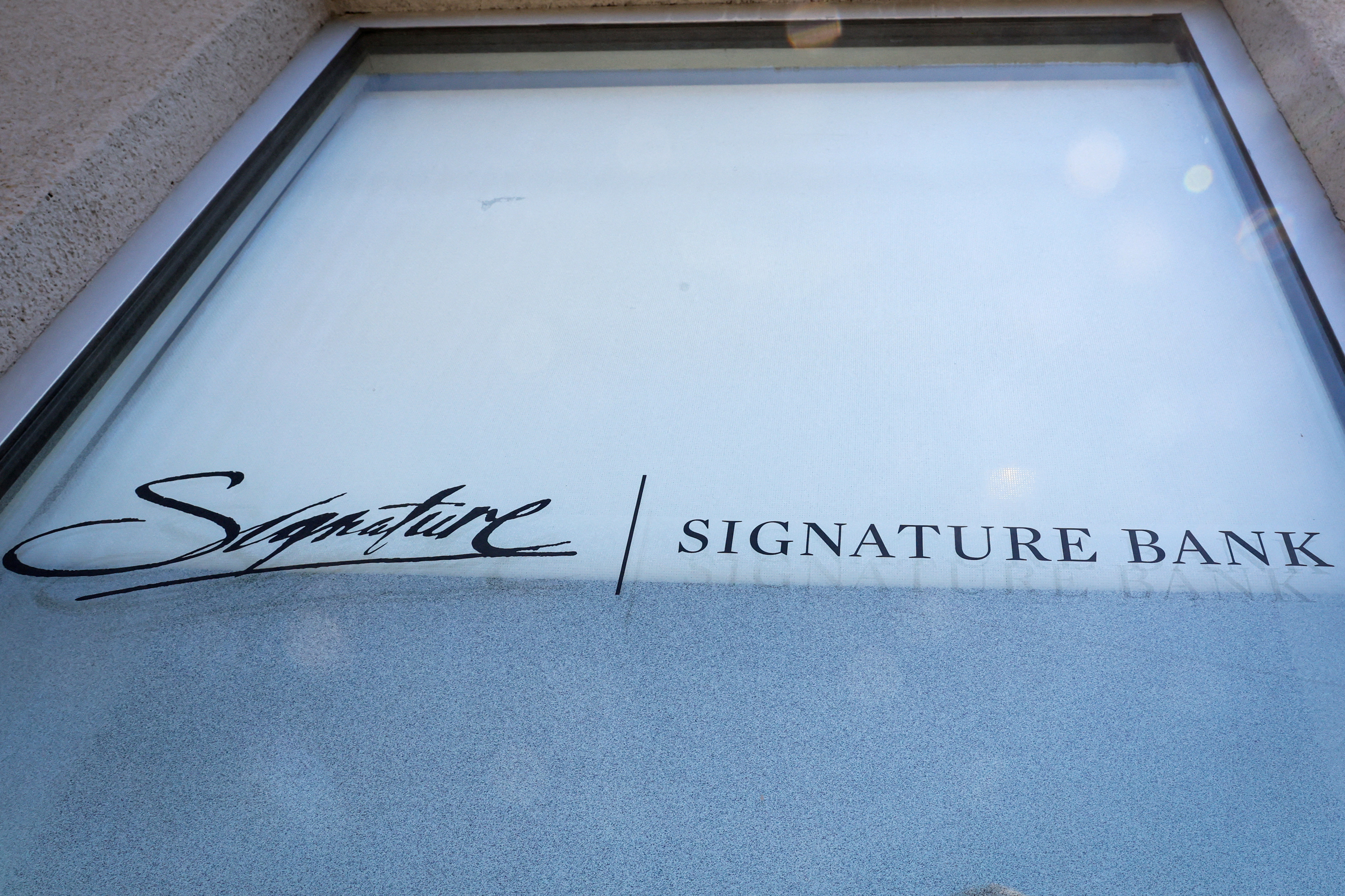 The company logo for Signature Bank is displayed at a location in Brooklyn, New York