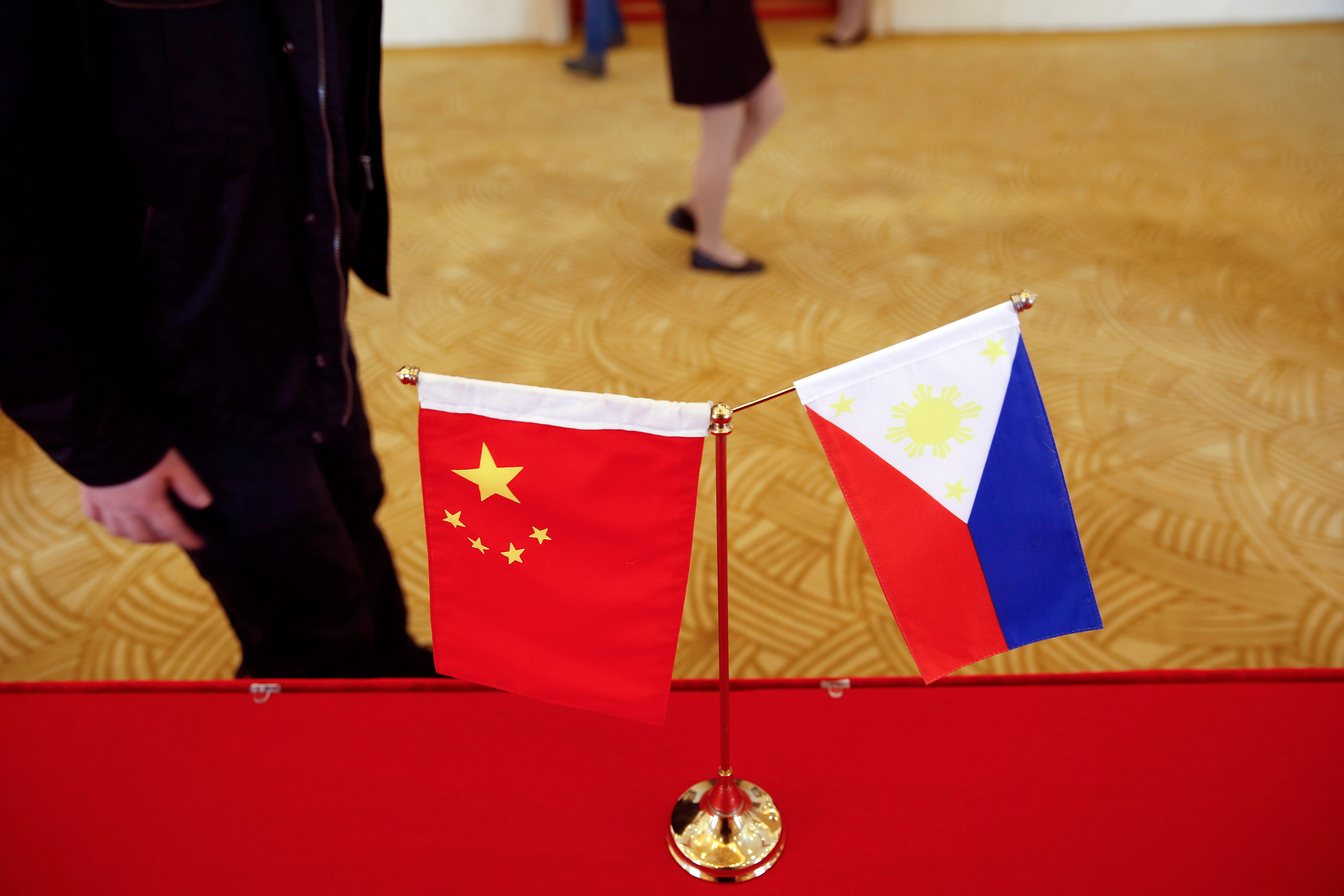 National flags are placed outside a room where Philippine Finance Secretary Carlos Dominguez and China's Commerce Minister Gao Hucheng address reporters after their meeting in Beijing